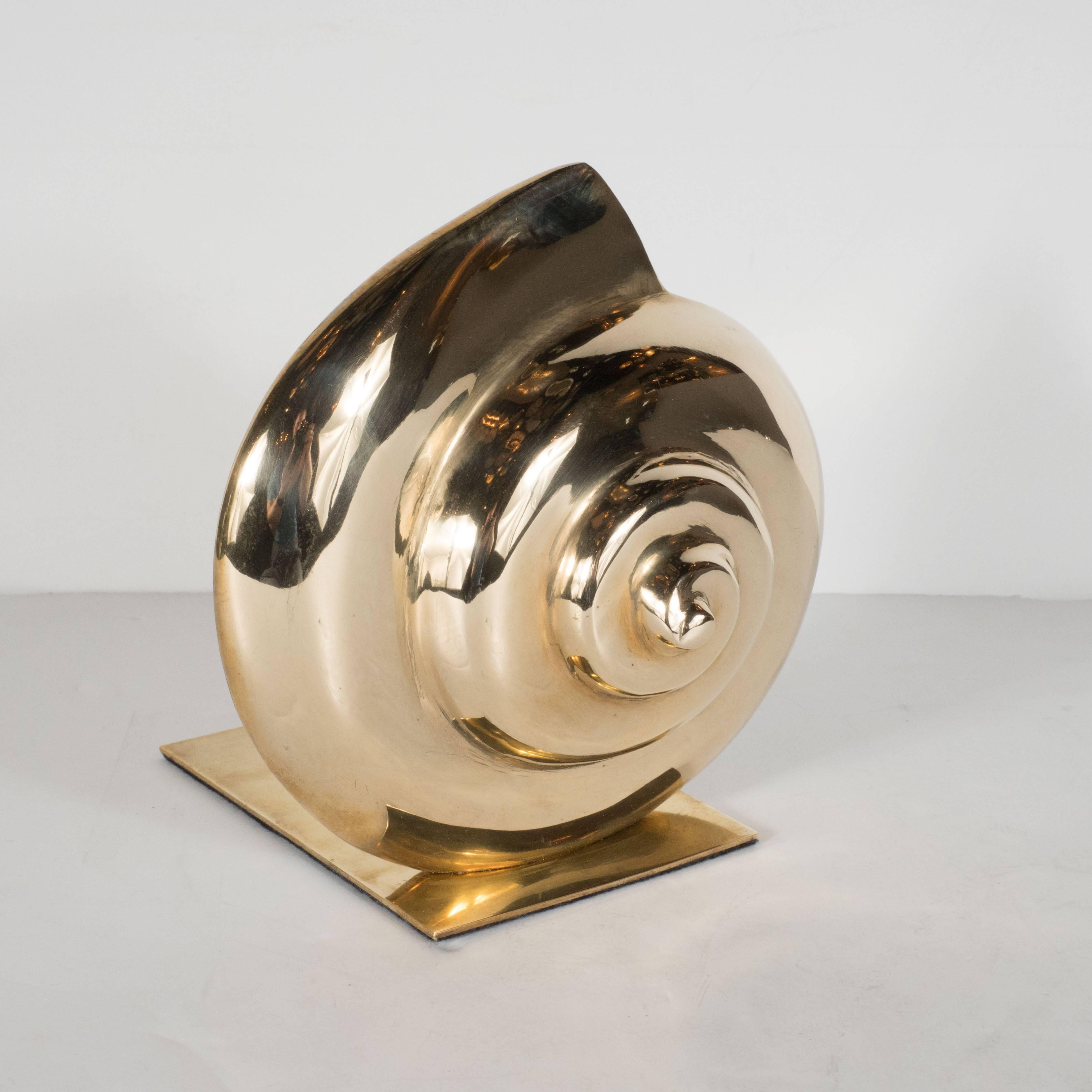 This Mid-Century Modernist pair of bookends offers abstracted sculptural renditions of the nautilus shell- a Classic inspiration in modern design (for everything from Vladimir Kagan chairs to Patek Phillipe watches)- realized in lustrous polished