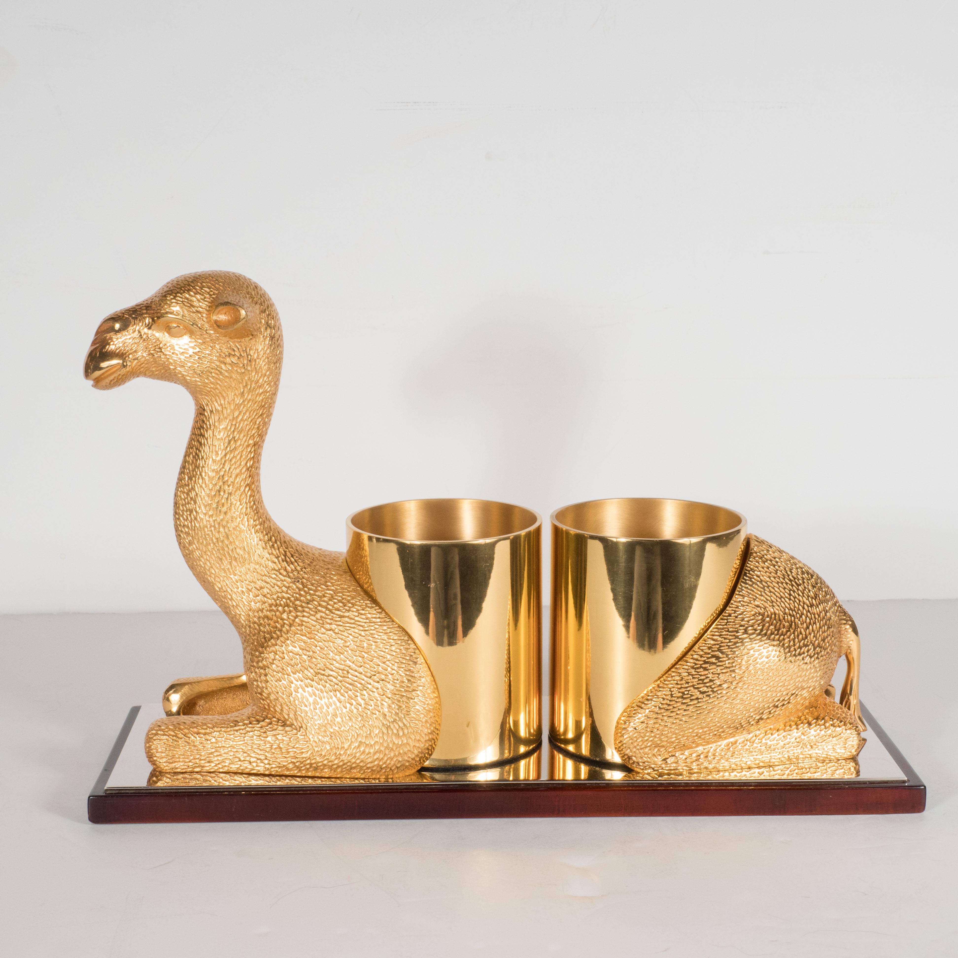 This ultra chic bottle holder features a whimsical sculpture of a supine camel replete with an elaborately dimpled exterior, representing its coat, and two cylindrical depressions in the center of its back perfect for accommodating two wine or