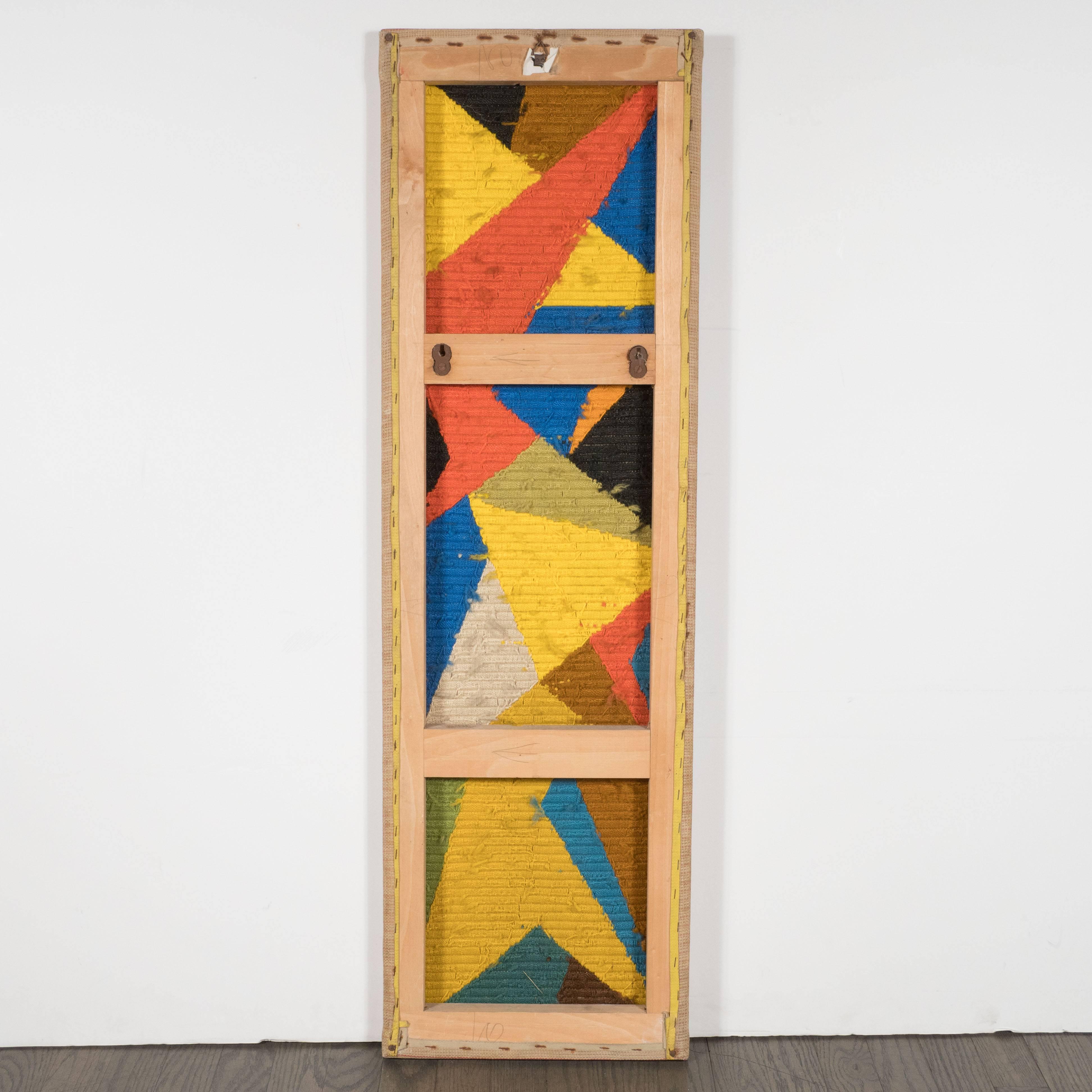 This compelling Mid-Century Modernist tapestry wall hanging was realized in tightly woven, hand-knotted cotton textile. The composition features an array of intersecting planes in a vibrant palate that includes hues of persimmon, hazelnut, lemon