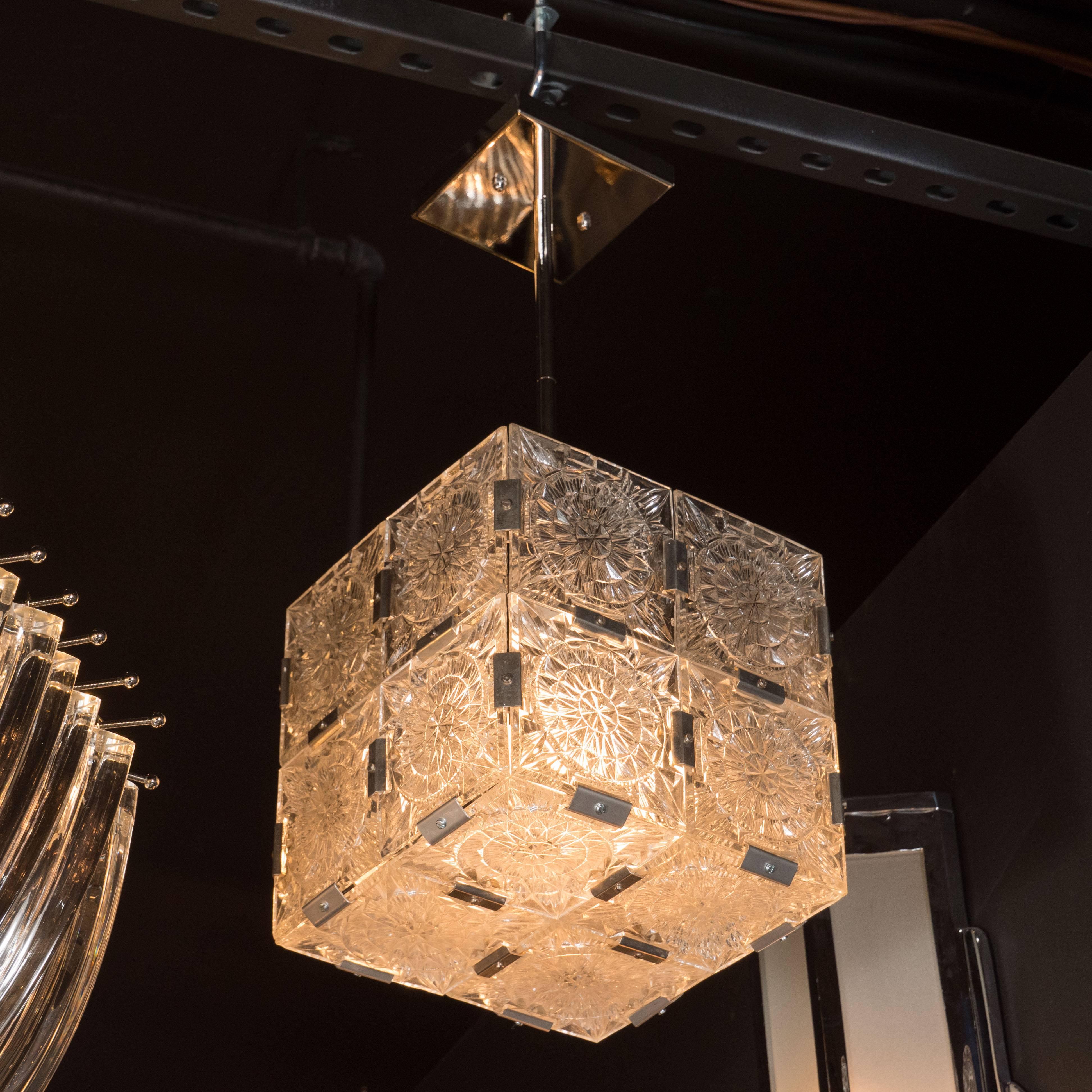 This elegant Mid-Century Modernist cube pendant was produced circa 1950 by the renowned Austrian maker Kinkeldy. Each side features four glass panels etched with an elaborate starburst pattern resembling an abstracted and illuminated woodcut print
