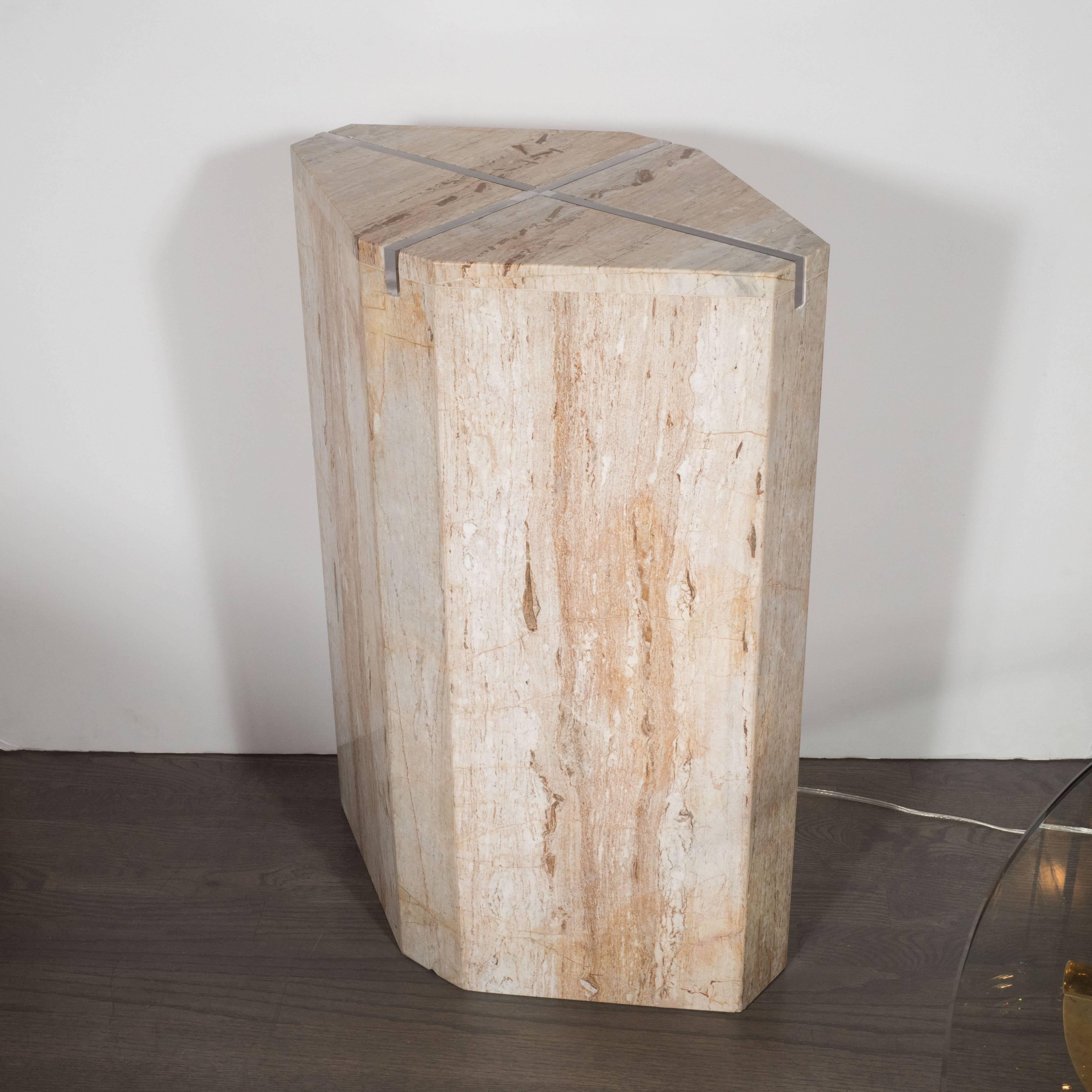 This refined pedestal is composed of an octagonally cut and perfectly polished slab of travertine marble with a cross-shaped illuminating insert in its center. The austere form highlights the inherent beauty of the marble- replete with hues of