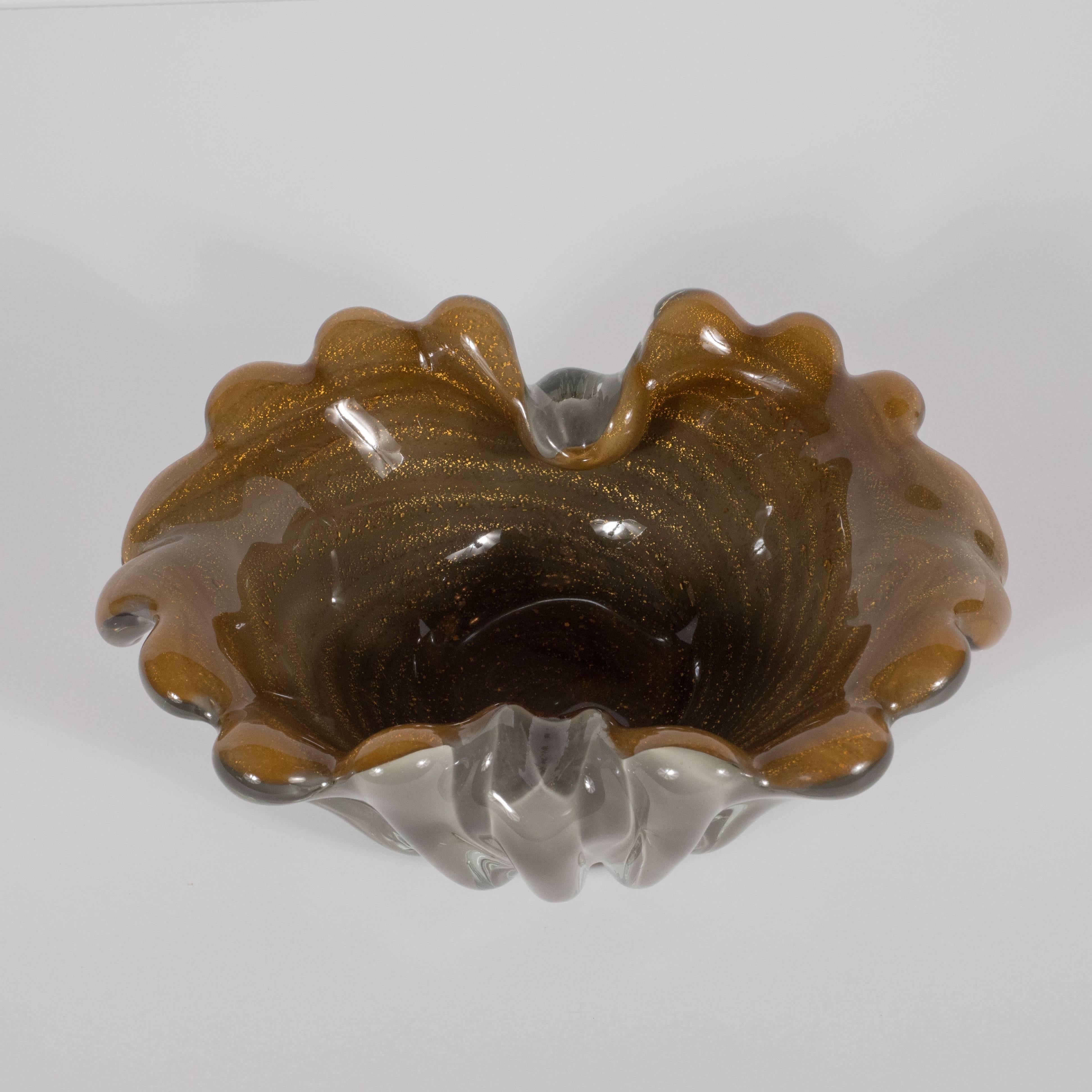 This classically Mid-Century Modern bowl was handblown on the fabled Venetian island of Murano renowned for its high quality glass production for centuries, circa 1950. This piece features a smoked pewter exterior enrobed in thick reeded tubes that