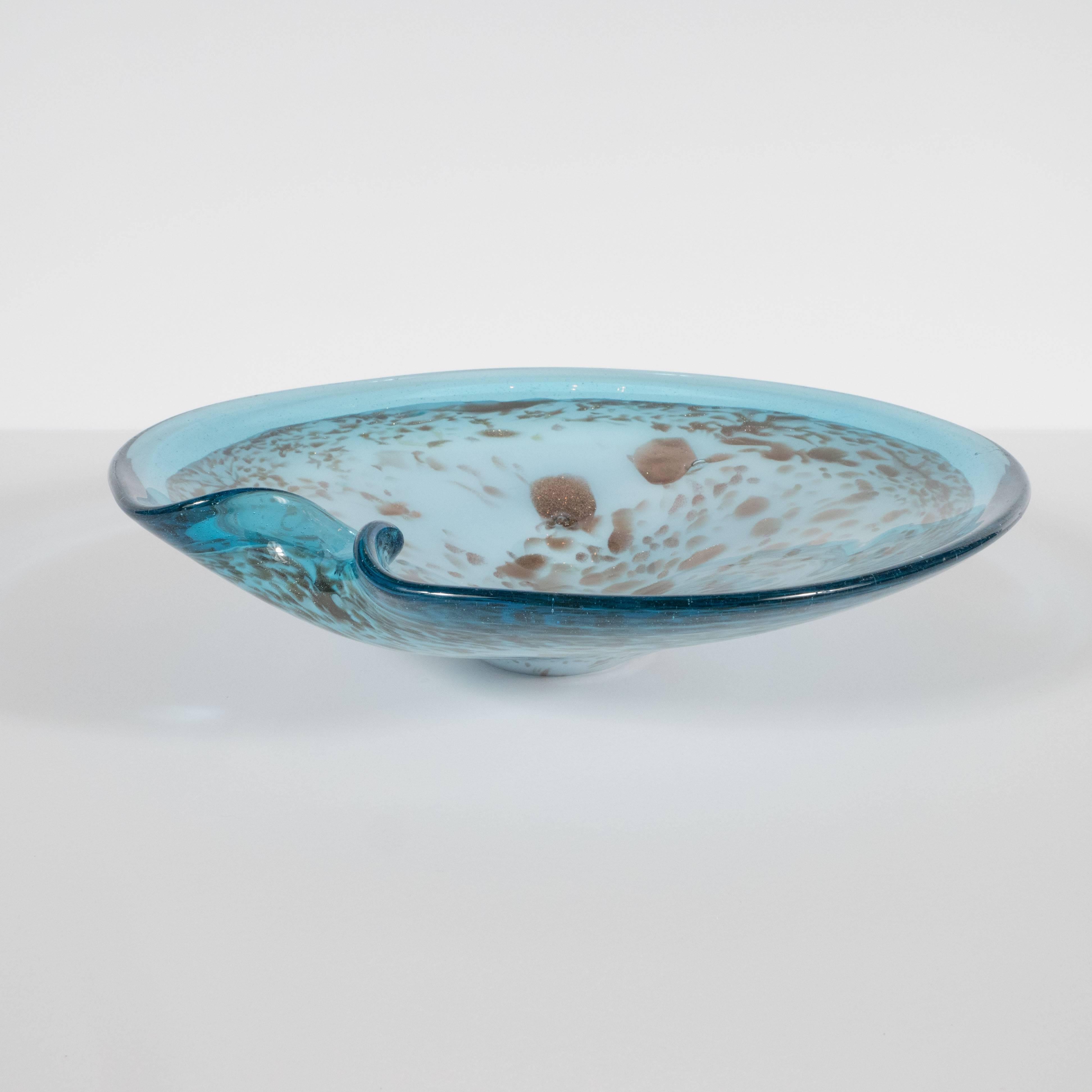 This stunning bowl was handblown, circa 1950, on the fabled Venetian island of Murano Italy. The center, realized in a Tiffany blue, teems with organic iridescent rose gold forms. Translucent azure glass with an abundance of miniscule bubbles