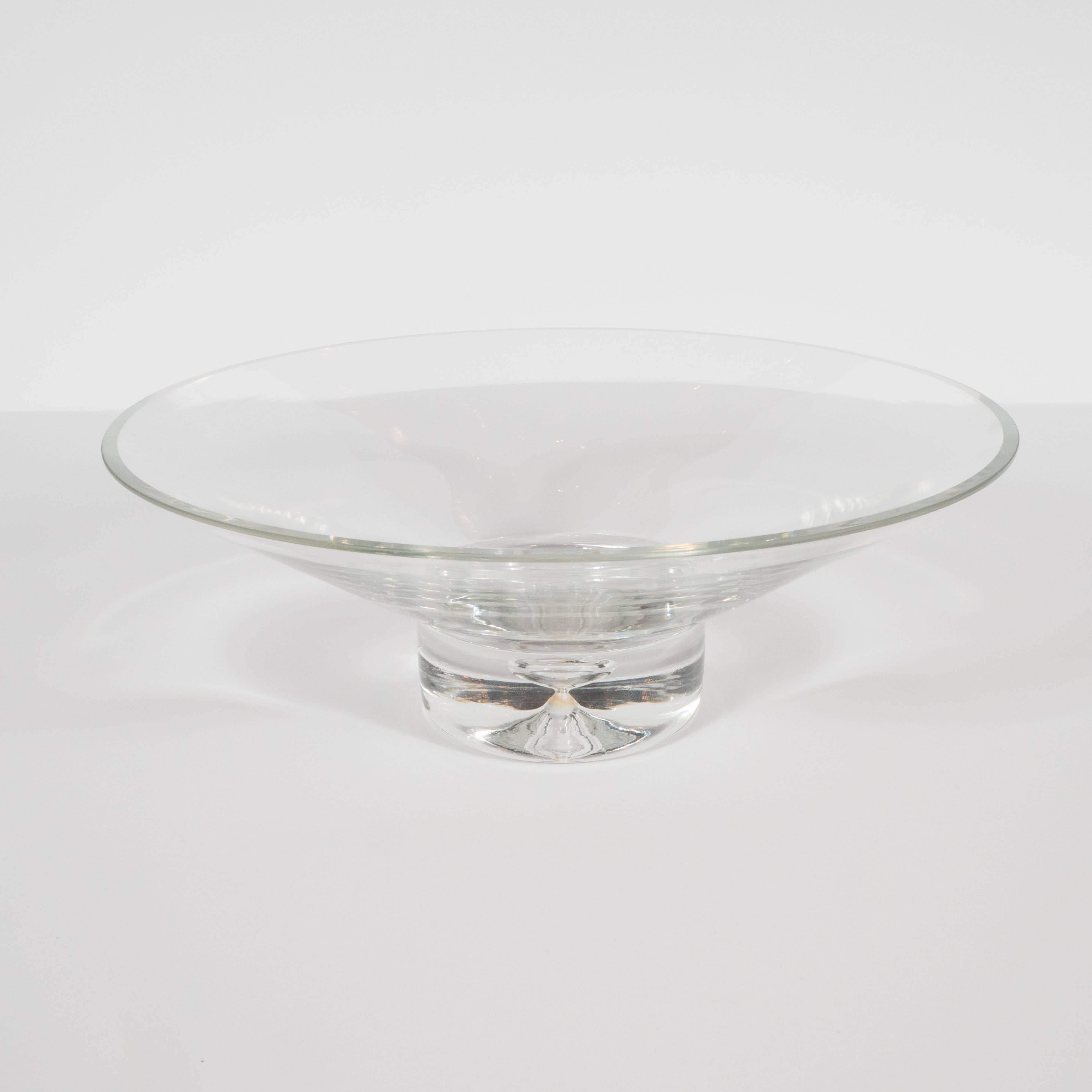 This refined Mid-Century Modern glass bowl was realized by Steuben Glass Works of Corning, New York, circa 1970. Steuben, founded in 1903, represents one of America's premier makers of glass products in the 20th century. This piece, with its elegant