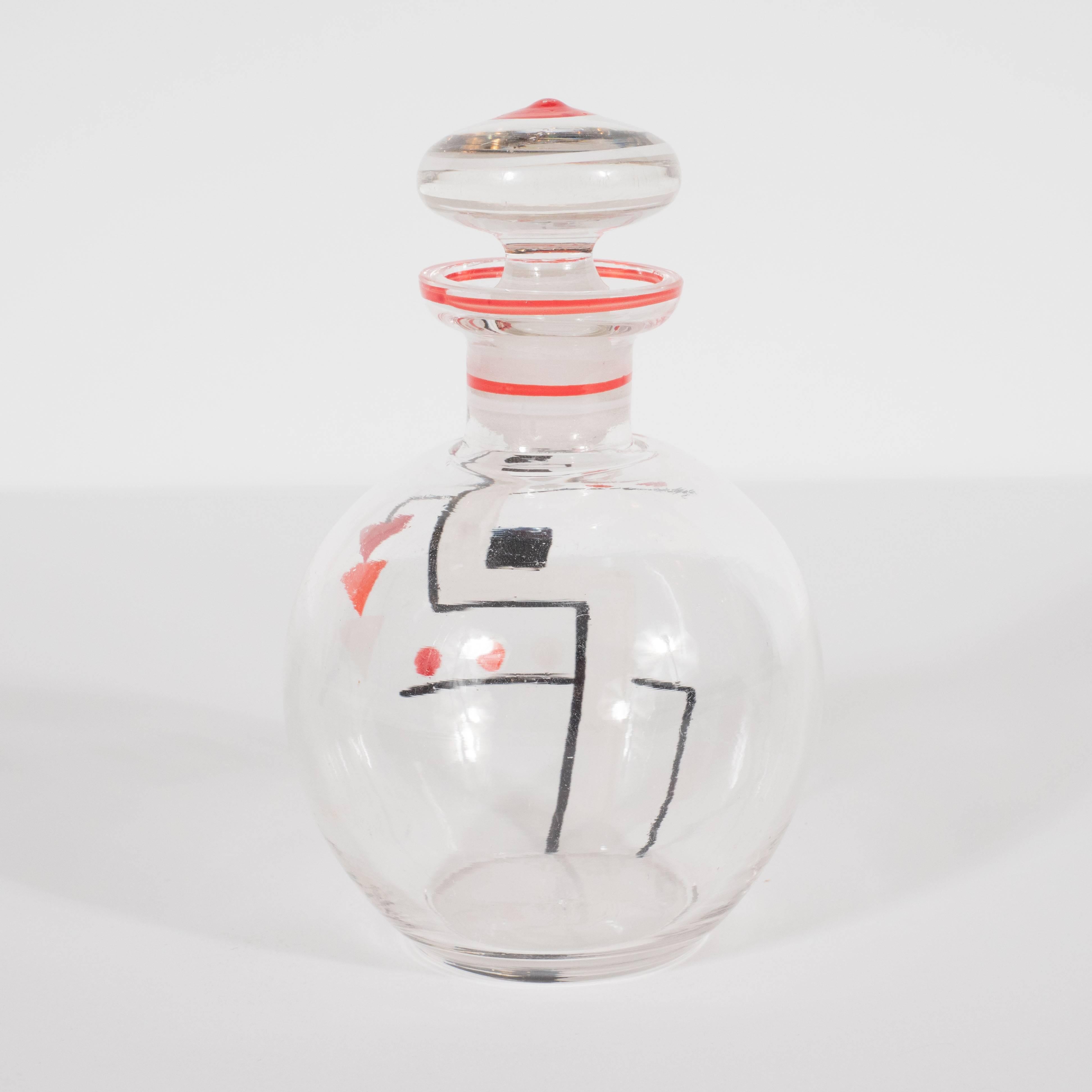 This sophisticated perfume bottle was realized, circa 1930, in the Czech Republic- a country renowned for its superlative glass products during this time period. This piece was fastidiously hand-painted with geometric forms, reflecting the influence