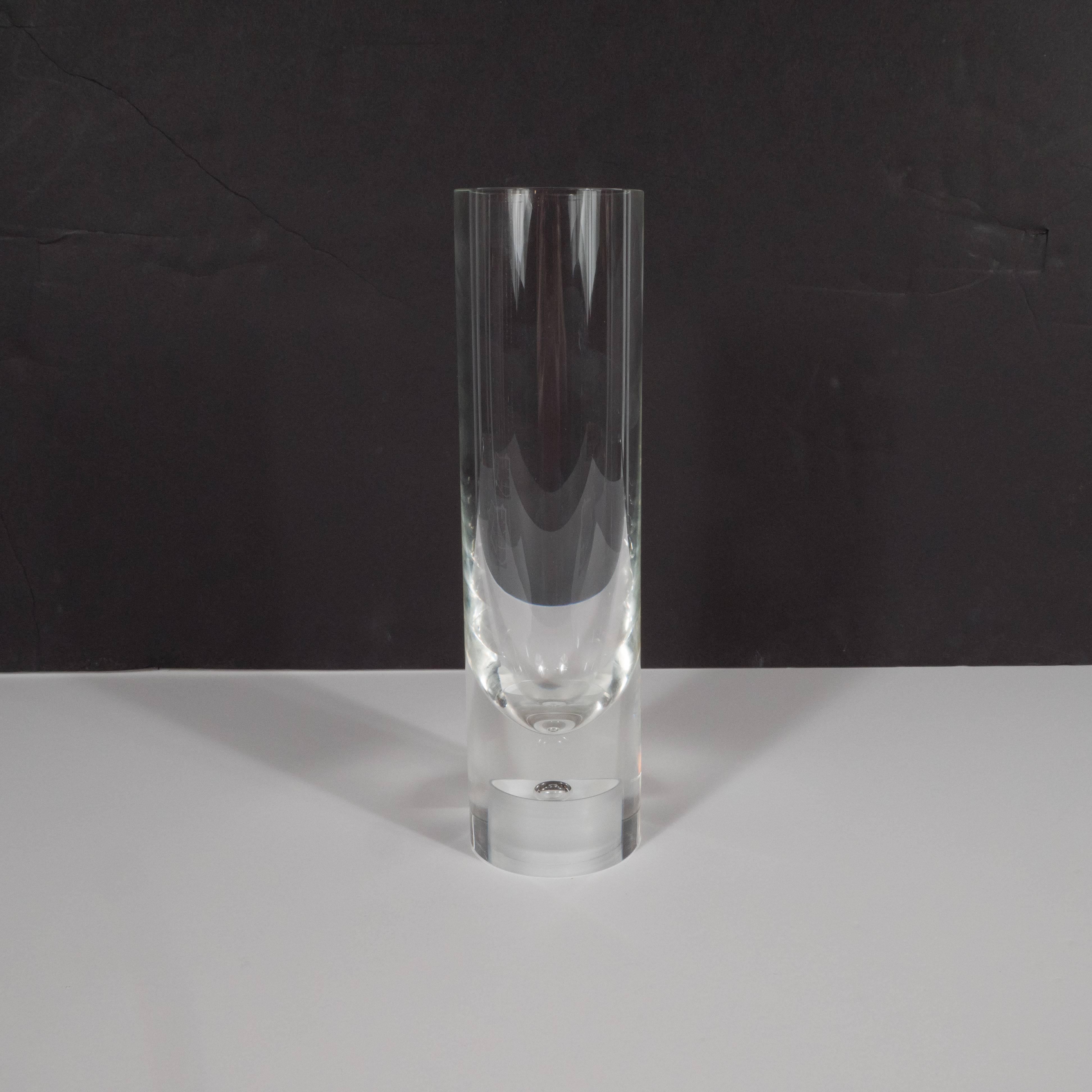 This refined clear glass vase was realized by Steuben Glass Works, of Corning New York, circa 1970. Steuben, founded in 1903, represents one of the most storied names in American blown glass of the 20th century. With its impeccable craftsmanship-