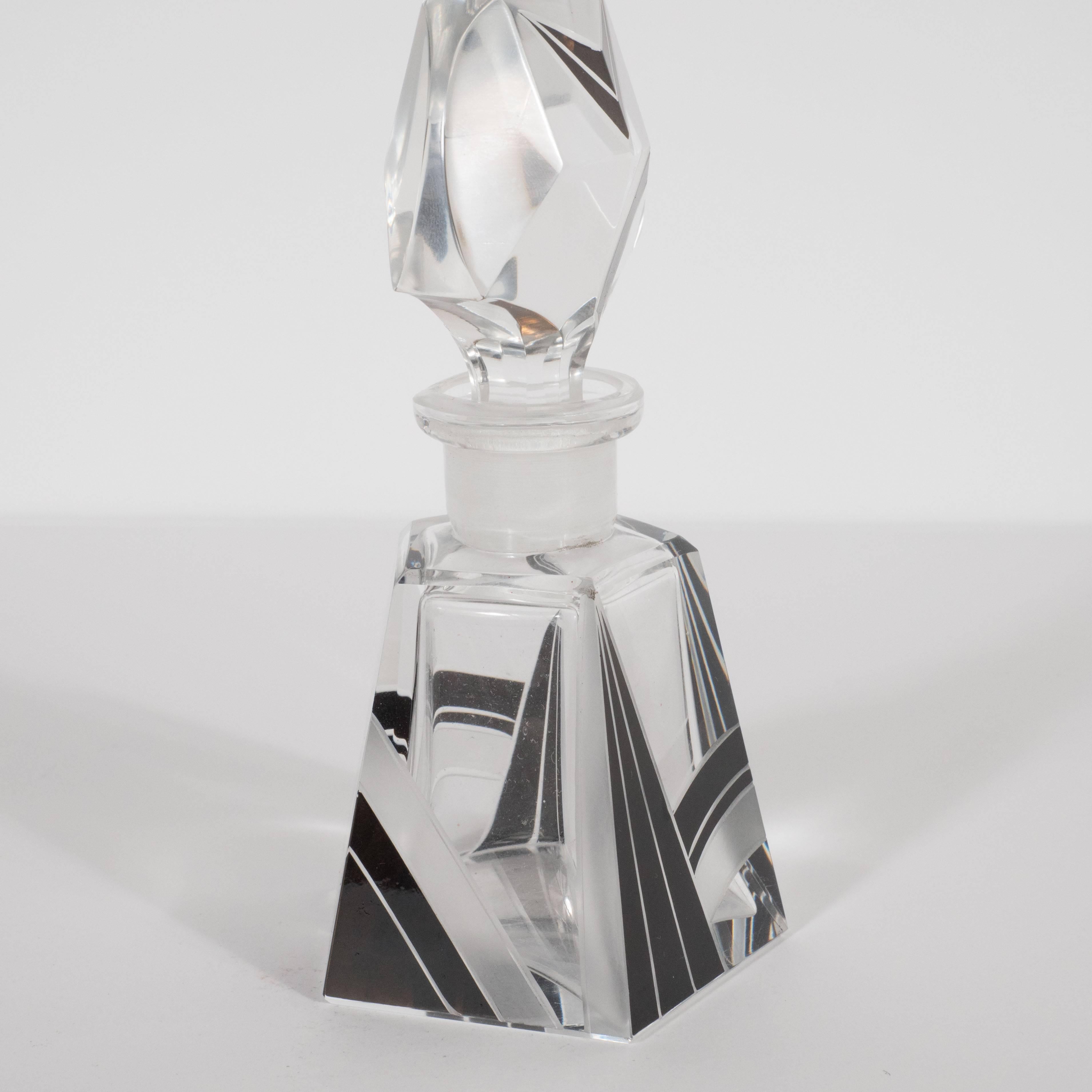 This refined Art Deco perfume bottle was realized in the Czech Republic (a country renowned for its glass production during this period), circa 1930. Its pentagonal form features a wealth of geometric cubist forms in black and frosted glass
