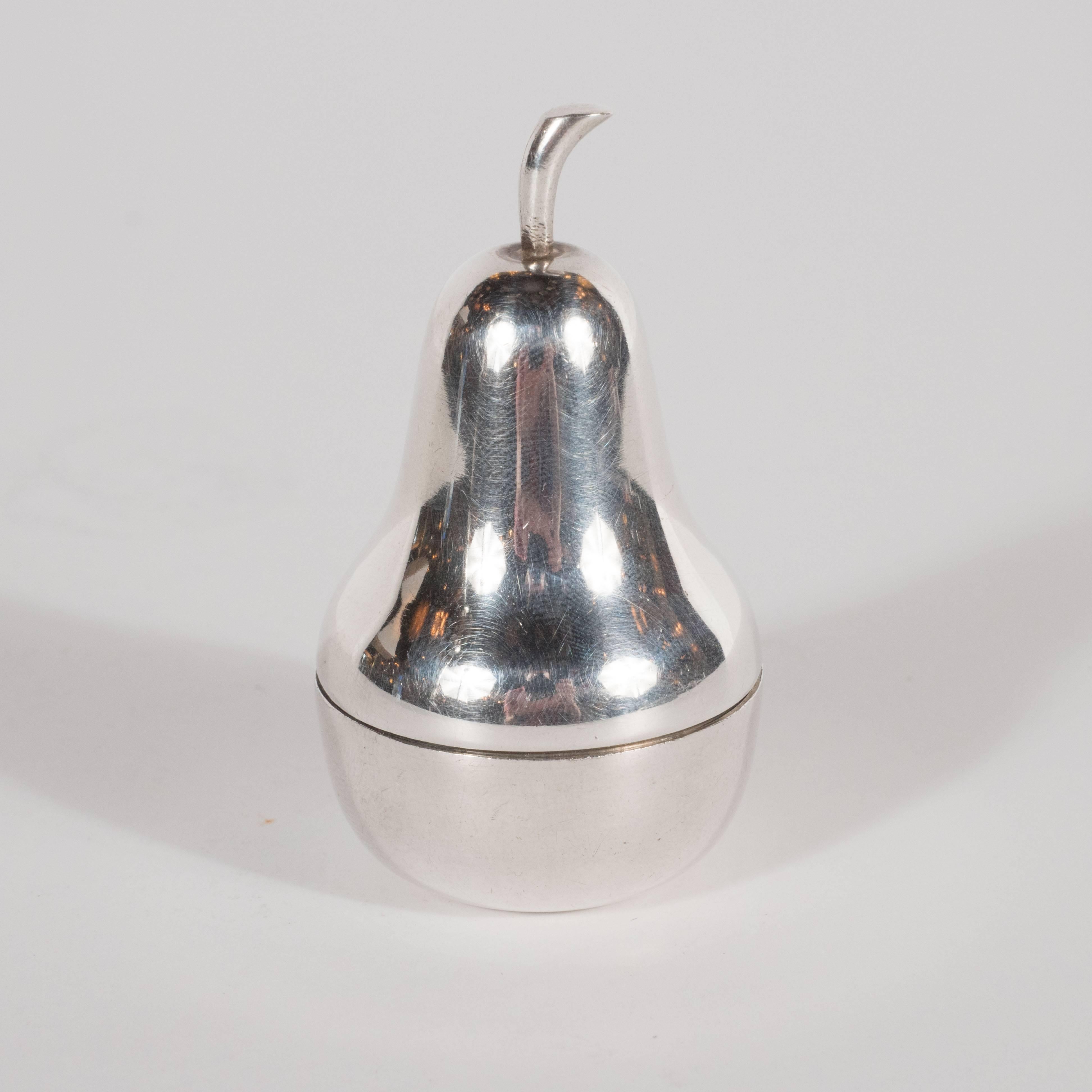 This chic sterling silver pear shaped pill box was realized by the fabled Tiffany & Co. the most revered name in American silver, circa 1960. With its clean flowing lines and impeccable surface, the quality of design and construction is apparent