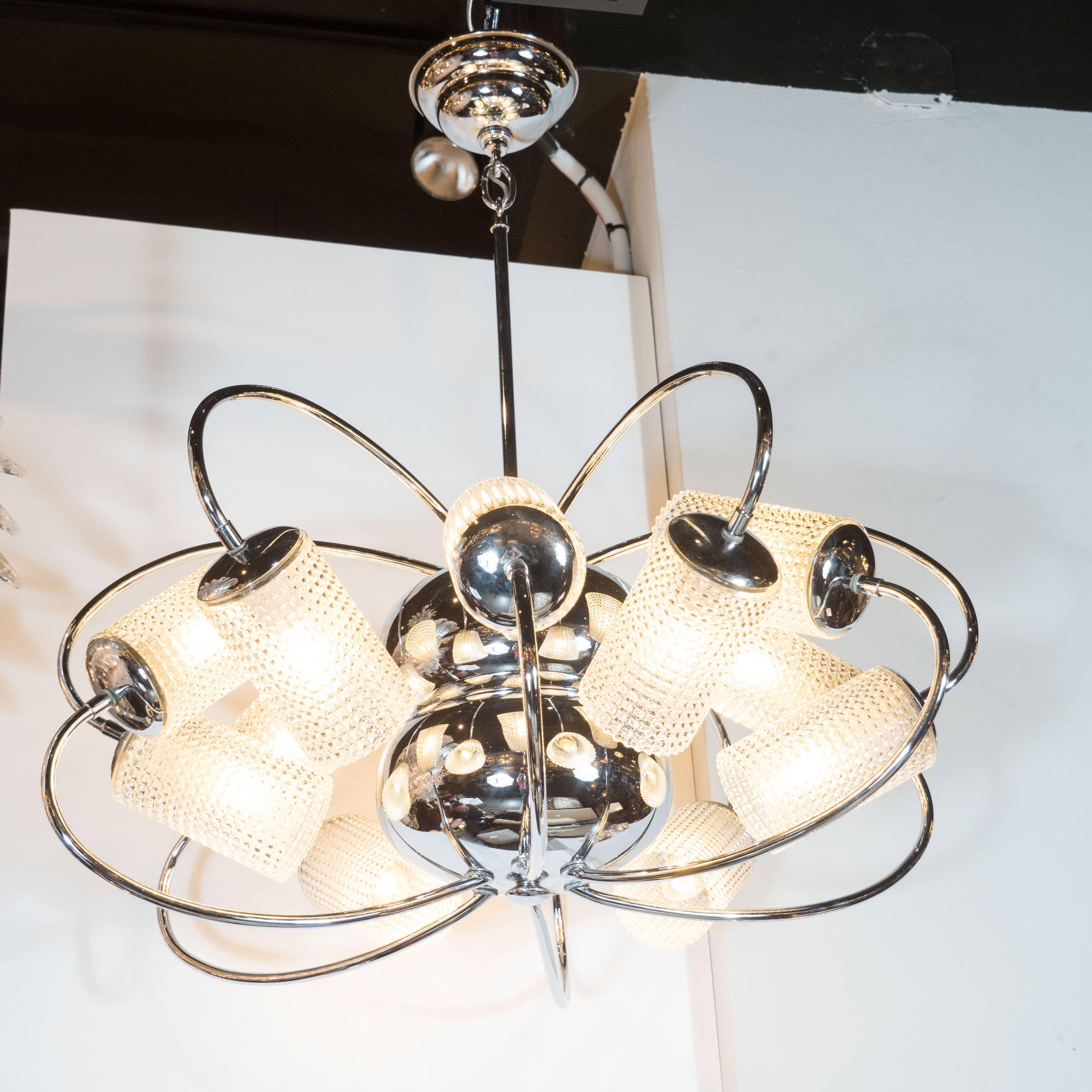 This stunning chandelier realized, circa 1950 in Italy- represents an exceptionally Fine example of the time and place. Resembling an oversized atom, the piece features twelve curved arms (six above and six below) connected to a central body
