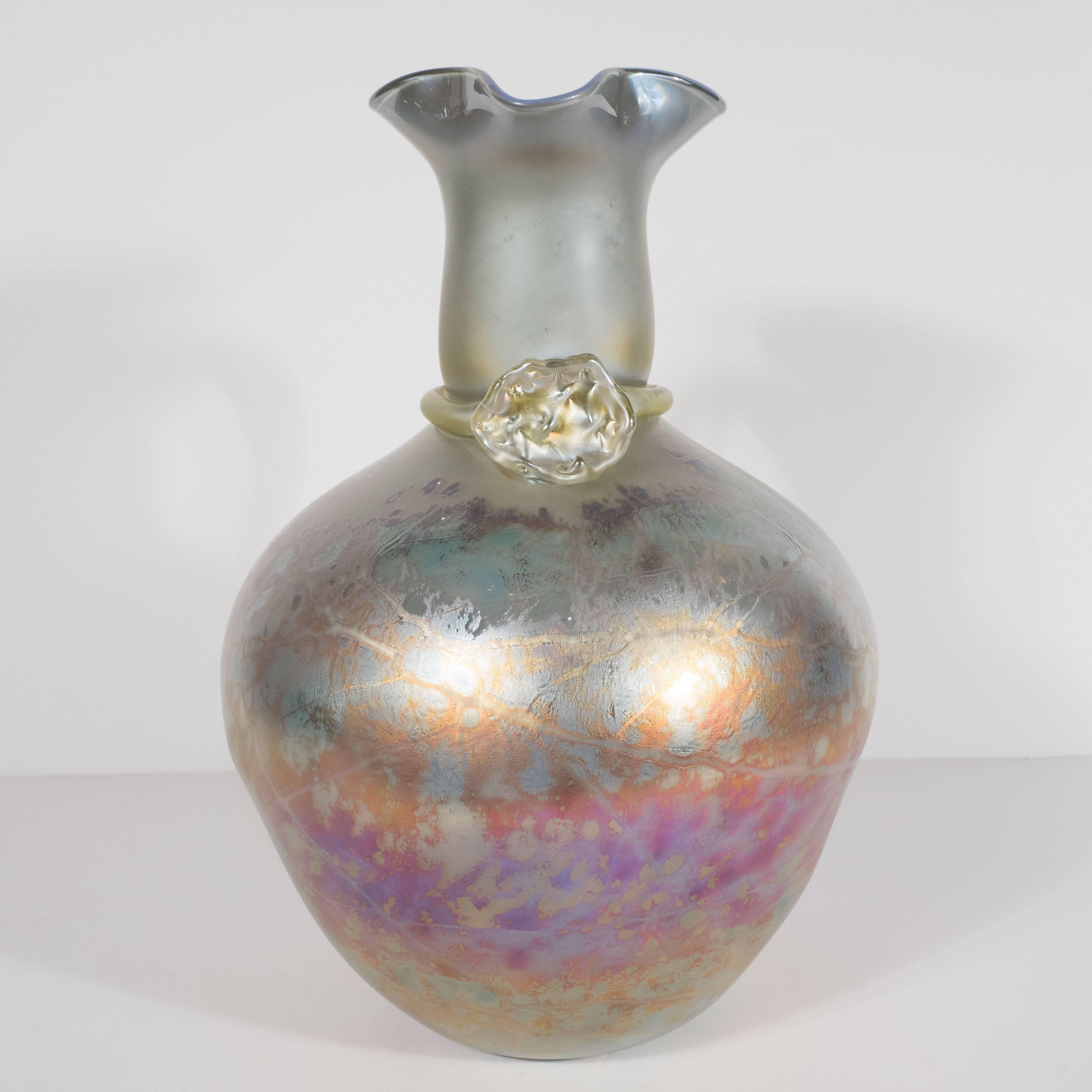 This stunning Etruscan vase was realized in Murano, Italy- the archipelago of Venetian Islands renowned for centuries for their superlative glass production, circa 1980. It was handblown in favrile glass with iridescent tones of coral, gold, and