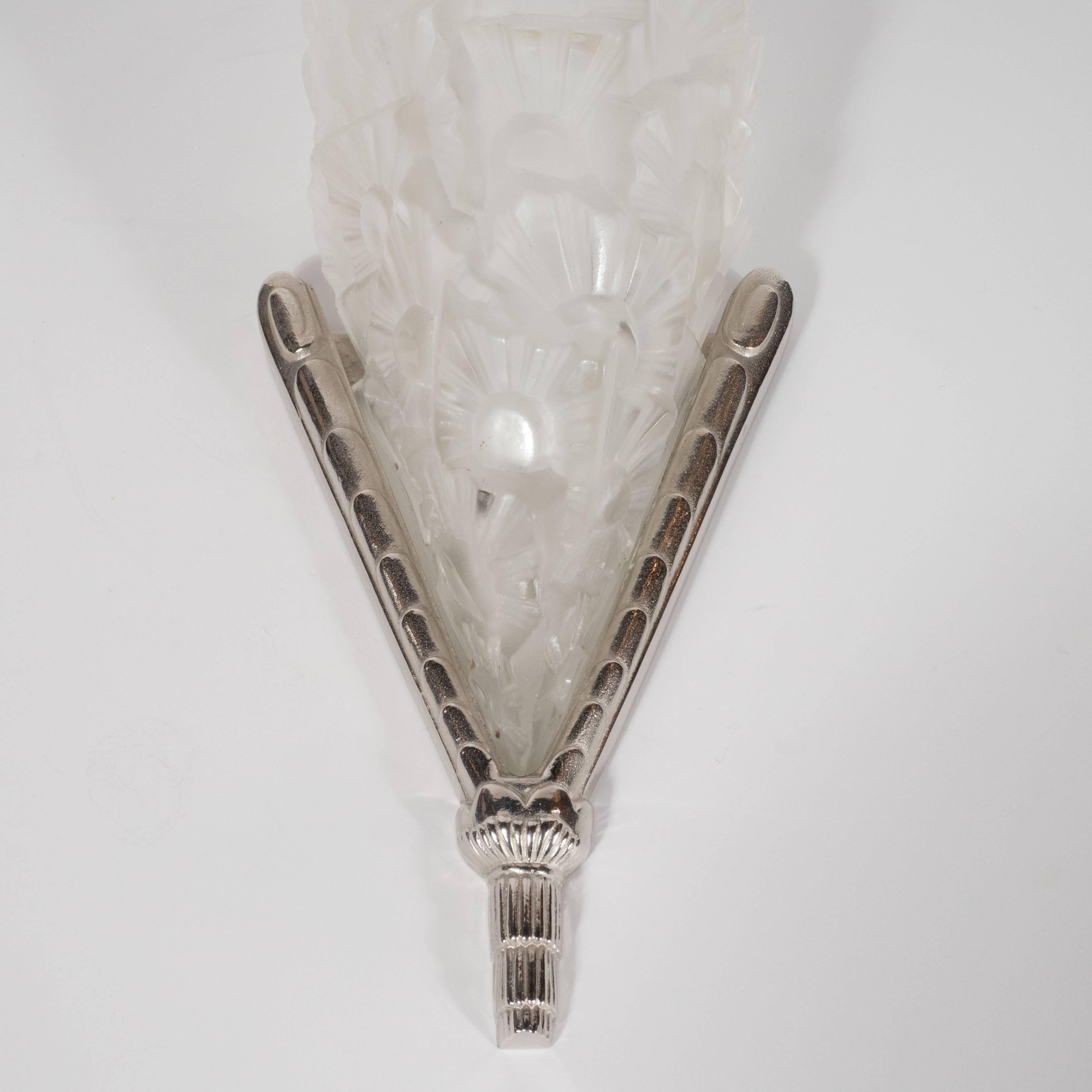 This stunning pair of sconces were produced by Degué, arguably the most illustrious glass making studio in France during this period, circa 1930. The fan style shades feature an abundance of raised, overlapping cubist forms that capture the dynamic