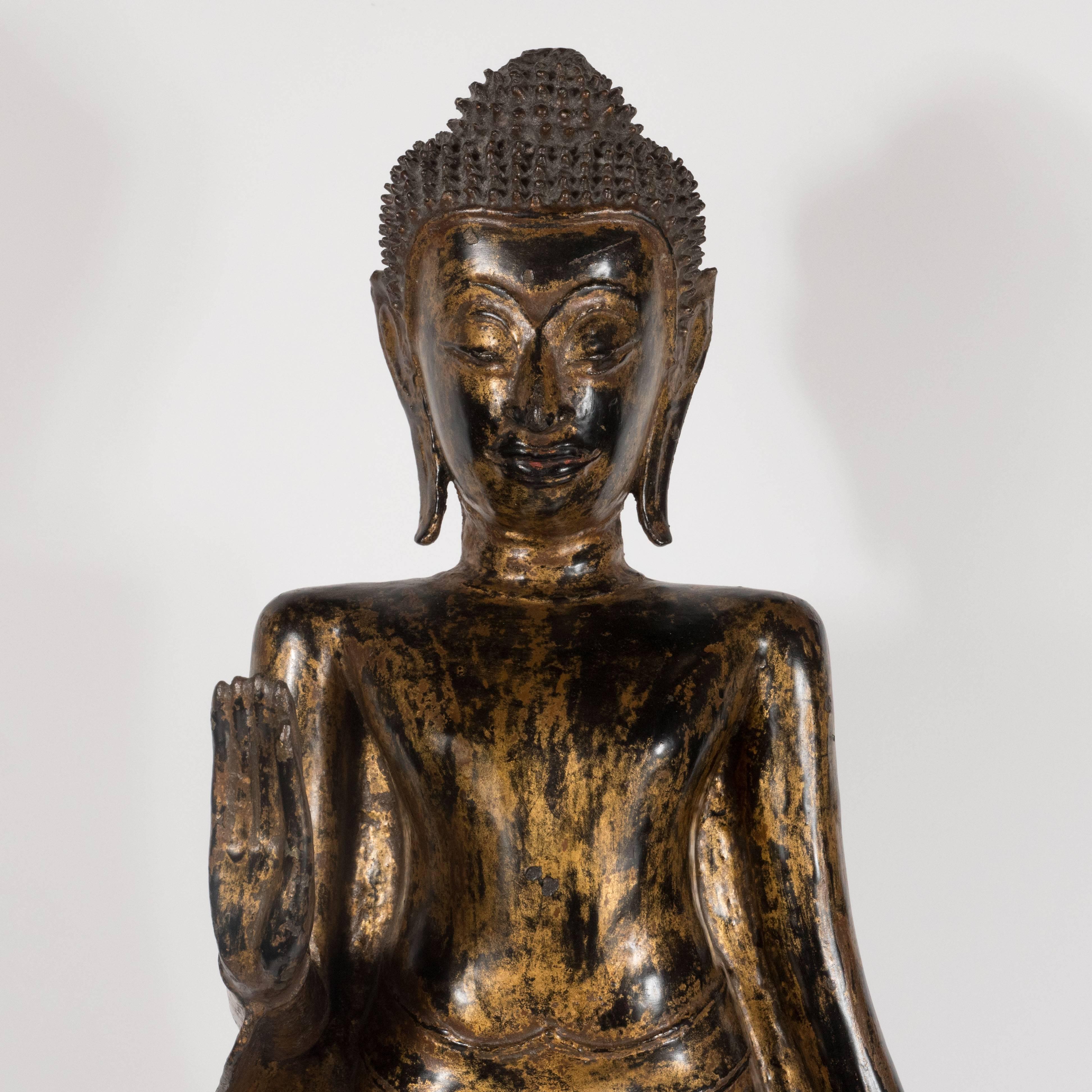 This quietly stunning Buddha was realized in Thailand during the 19th century. It represents an exceptionally fine example of the period. The Buddha wears a long flowing robe. His Ushnisha- or crown of hair- consists of an abundance of small raised