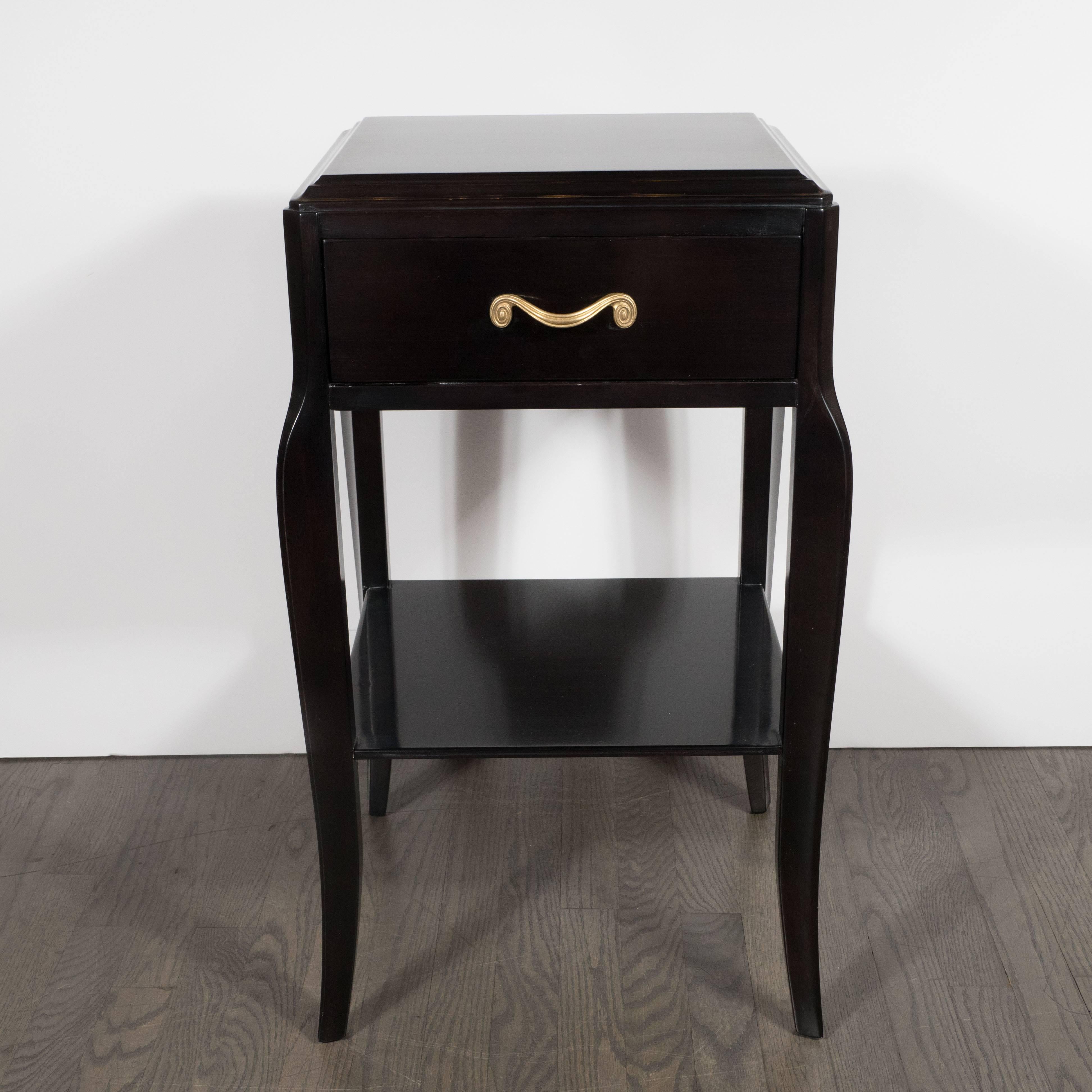 This refined pair of Mid-Century Modern nightstands in ebonized mahogany were realized by the esteemed American producer Grosfeld House, circa 1945. Some of the 20th centuries most legendary designers began their careers at Grosfeld House including