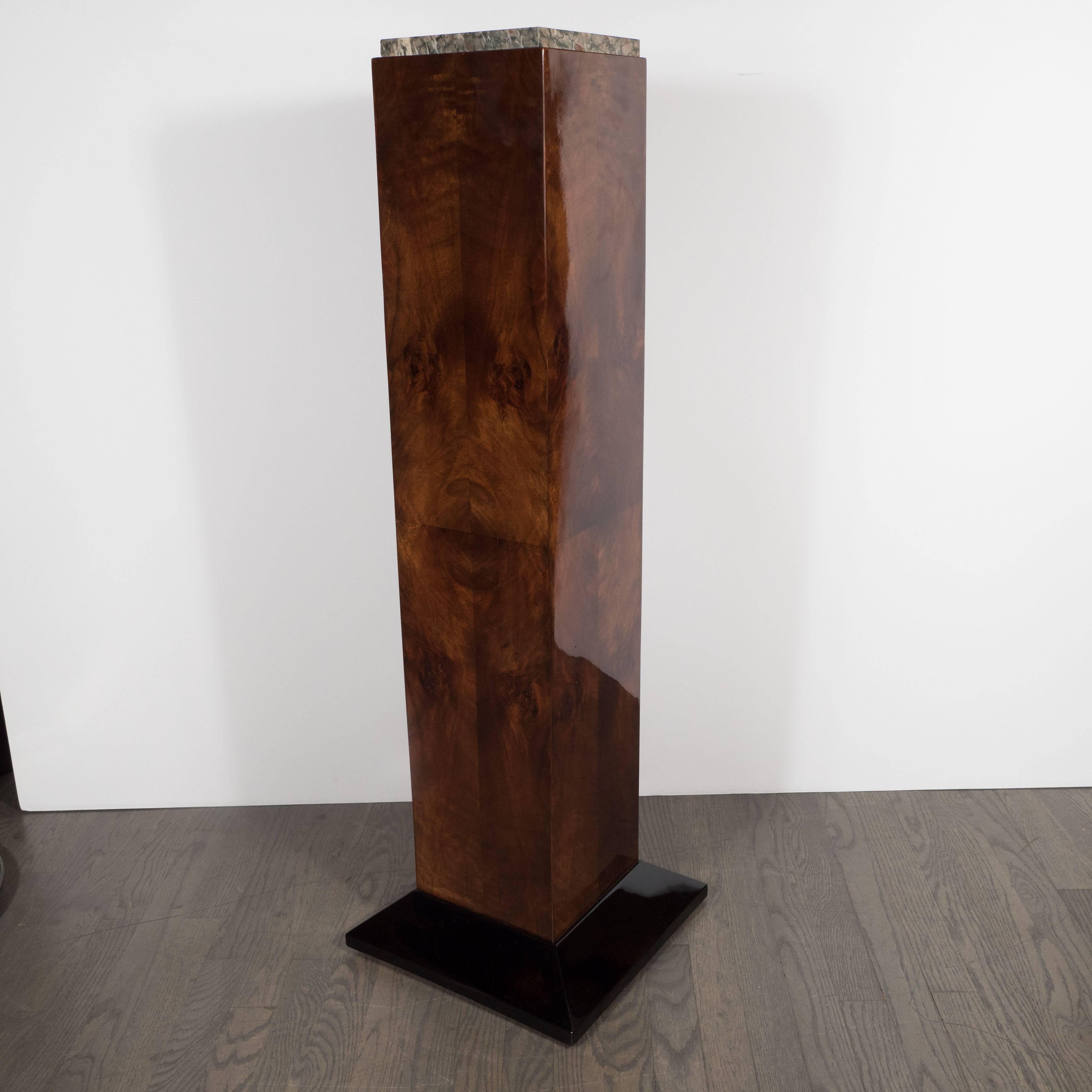 This refined pedestal- with its stunning contrast of book matched and burled walnut, exotic marble and black lacquer- was realized in France, circa 1930, at the height of Art Deco. It represents an exceptionally fine example of the time and place.