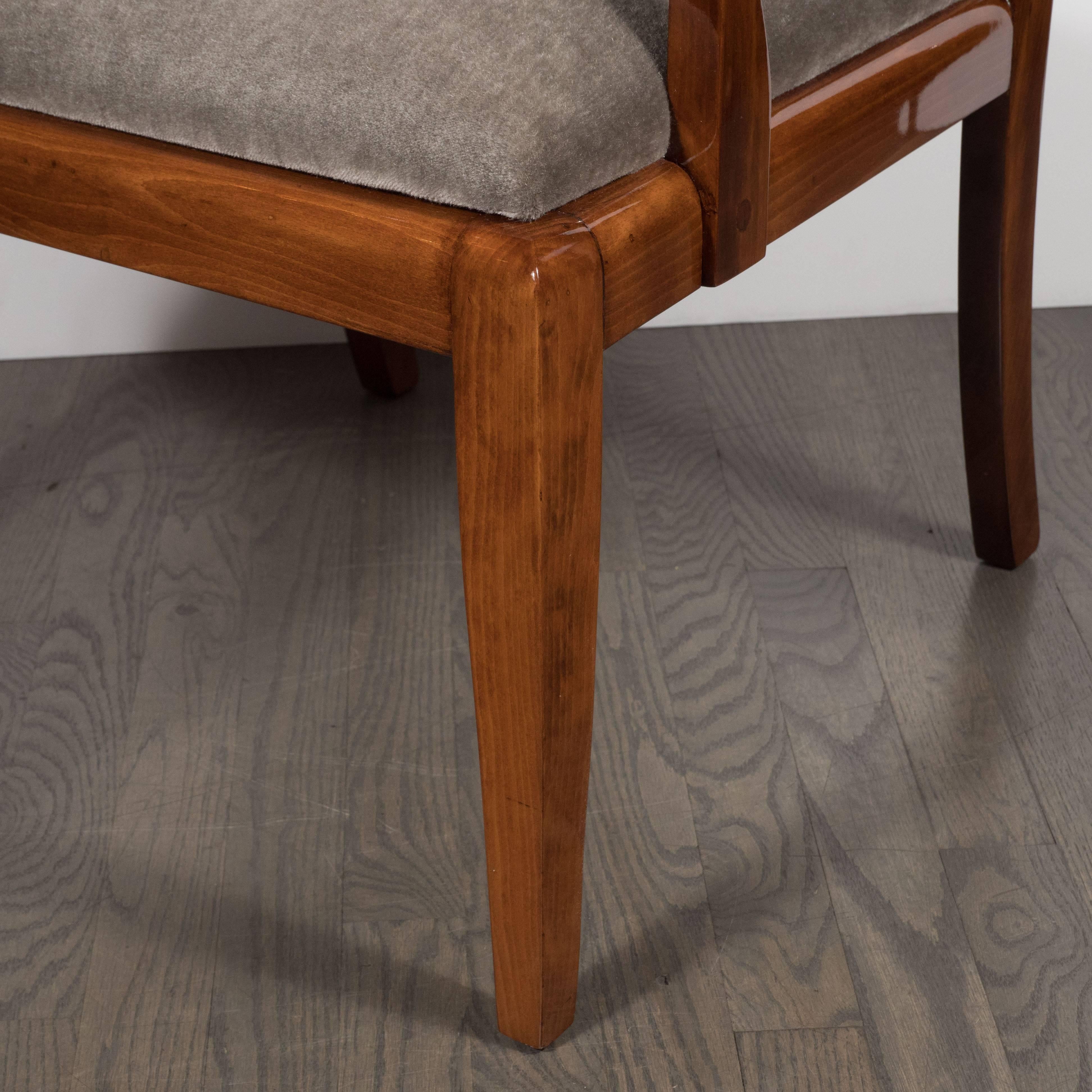This stunning occasional chair was realized in the United States, circa 1930, from polished walnut. It is a unique and idiosyncratic example of Art Deco Machine Age design in America, sure to delight any collector of the period. It features saber