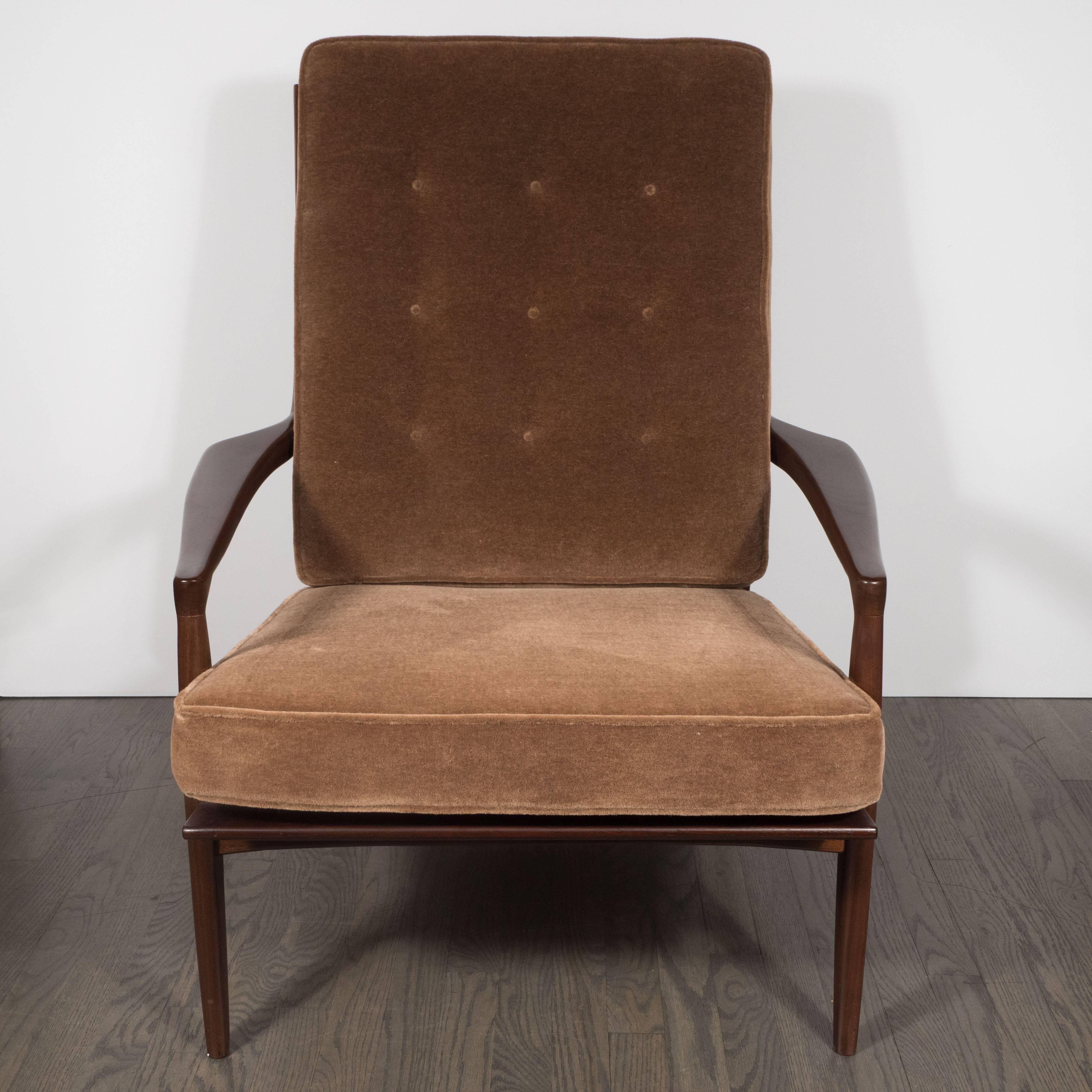 This sophisticated Mid-Century Modern hand rubbed walnut armchair was realized by Milo Baughman for Thayer Coggin circa 1970. It represents an exceptionally fine example of the period-biomorphic and sculptural offering the sinuous curves that