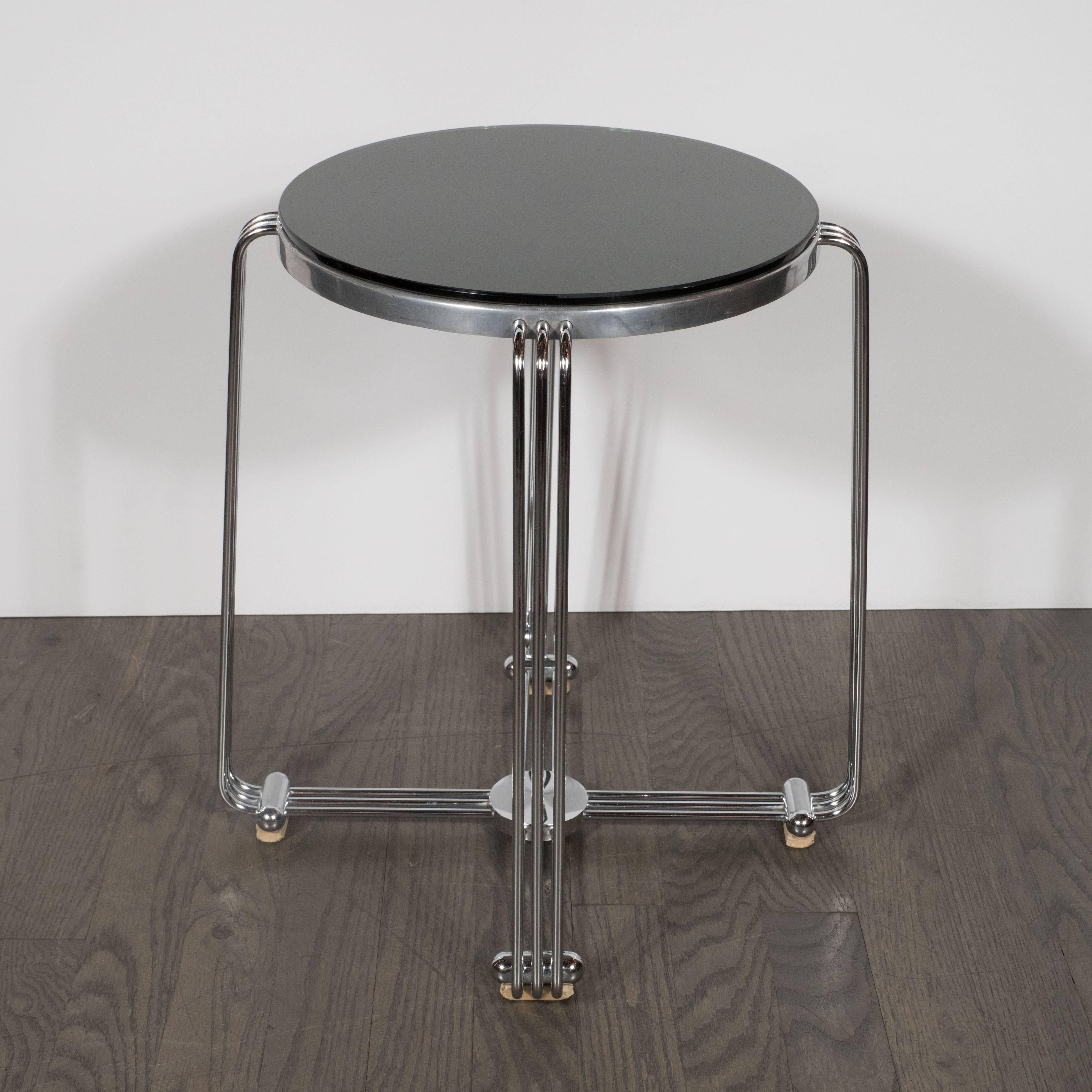 This refined drinks table exemplifies Machine Age Art Deco in America at its finest. With its streamlined Silhouette and clean lines, this table showcases designers from this epoch's ability to elevate Industrial materials to the sublime. The