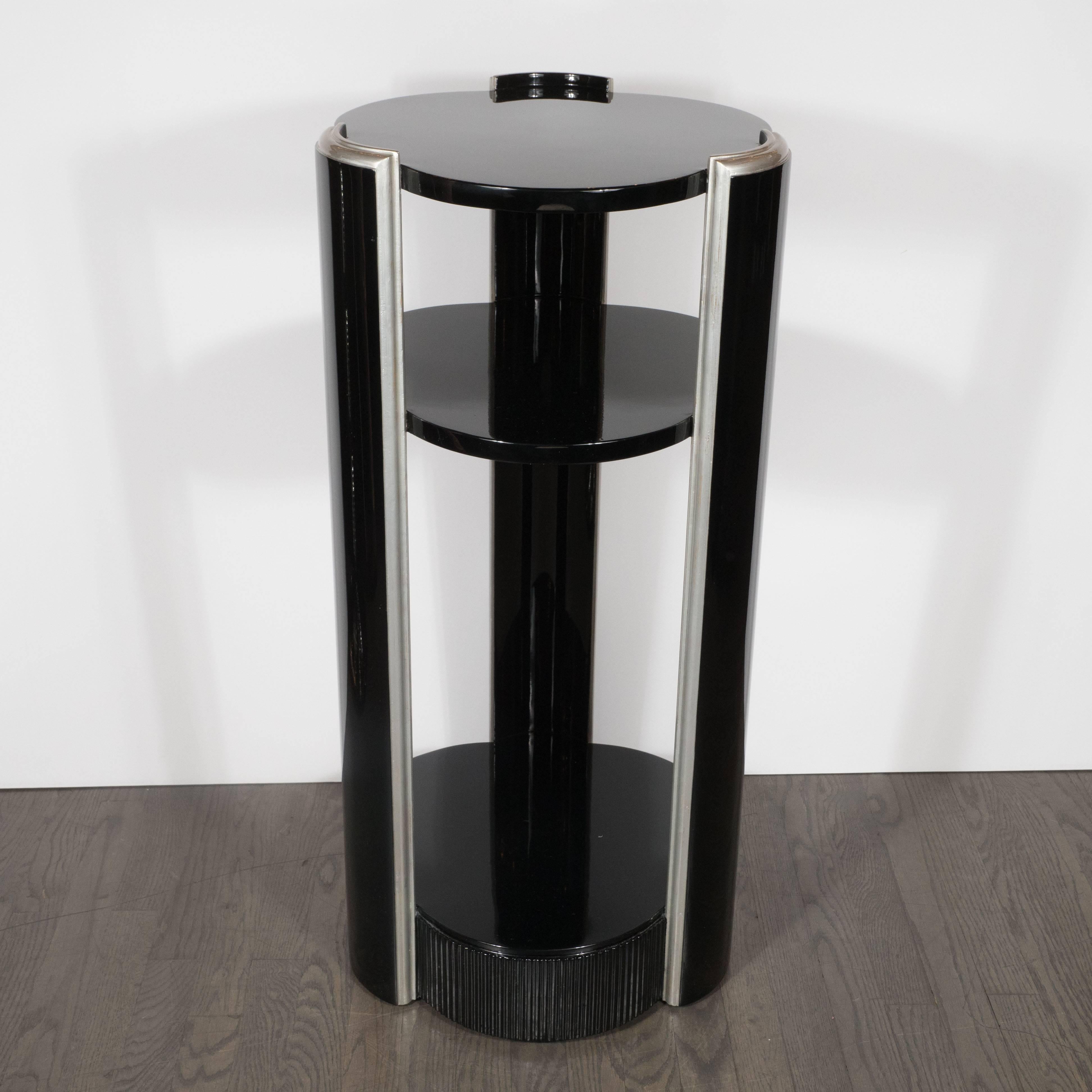 This refined black lacquer pedestal features three clover shaped tops, resembling Van Cleef & Arpels 