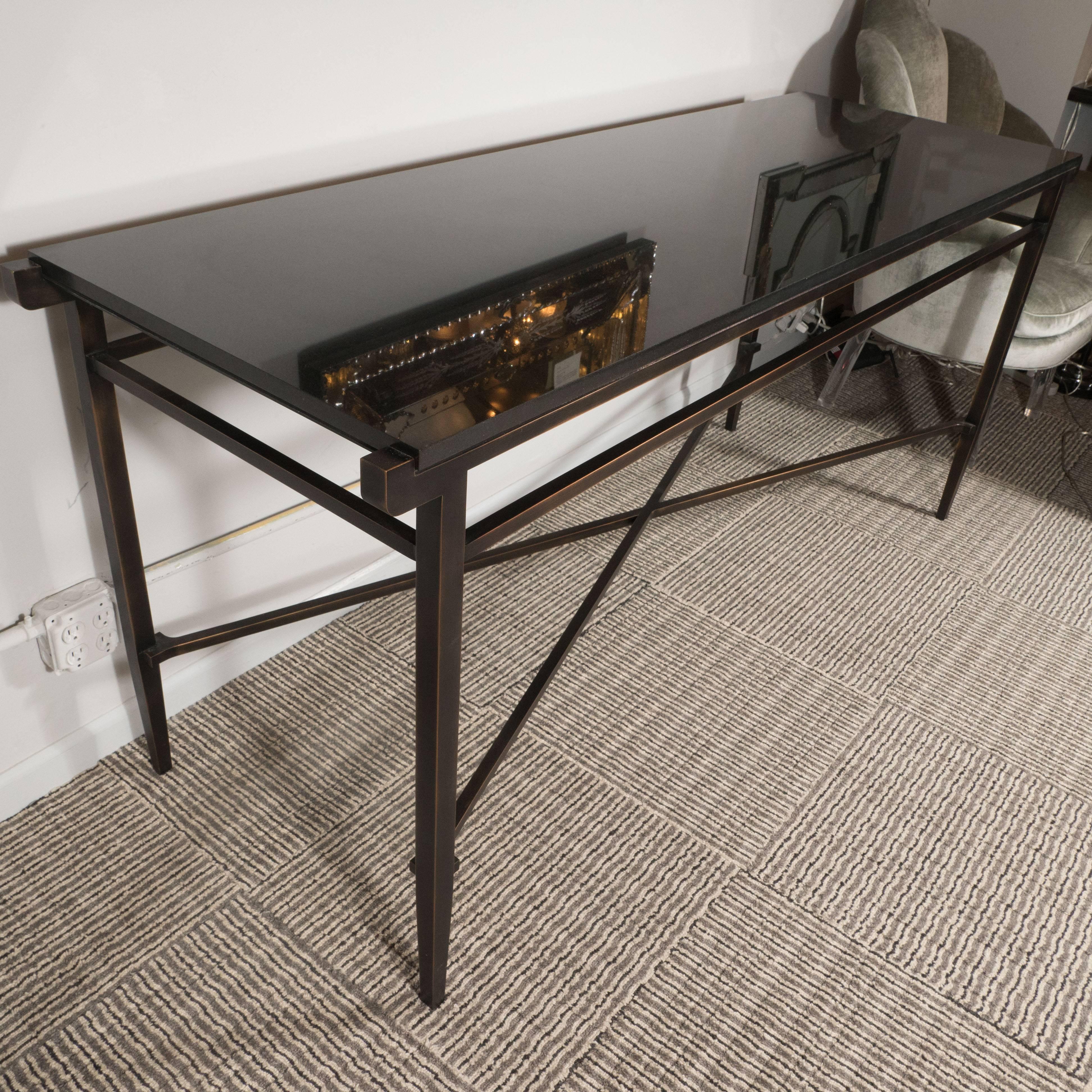 This sophisticated Mid-Century Modern table was custom-made by the esteemed designer Noel Jeffrey in the United States, circa 1980. It embodies the refined aesthetic and attention to detail that we prize. The hand rubbed bronze offers a subtle tonal