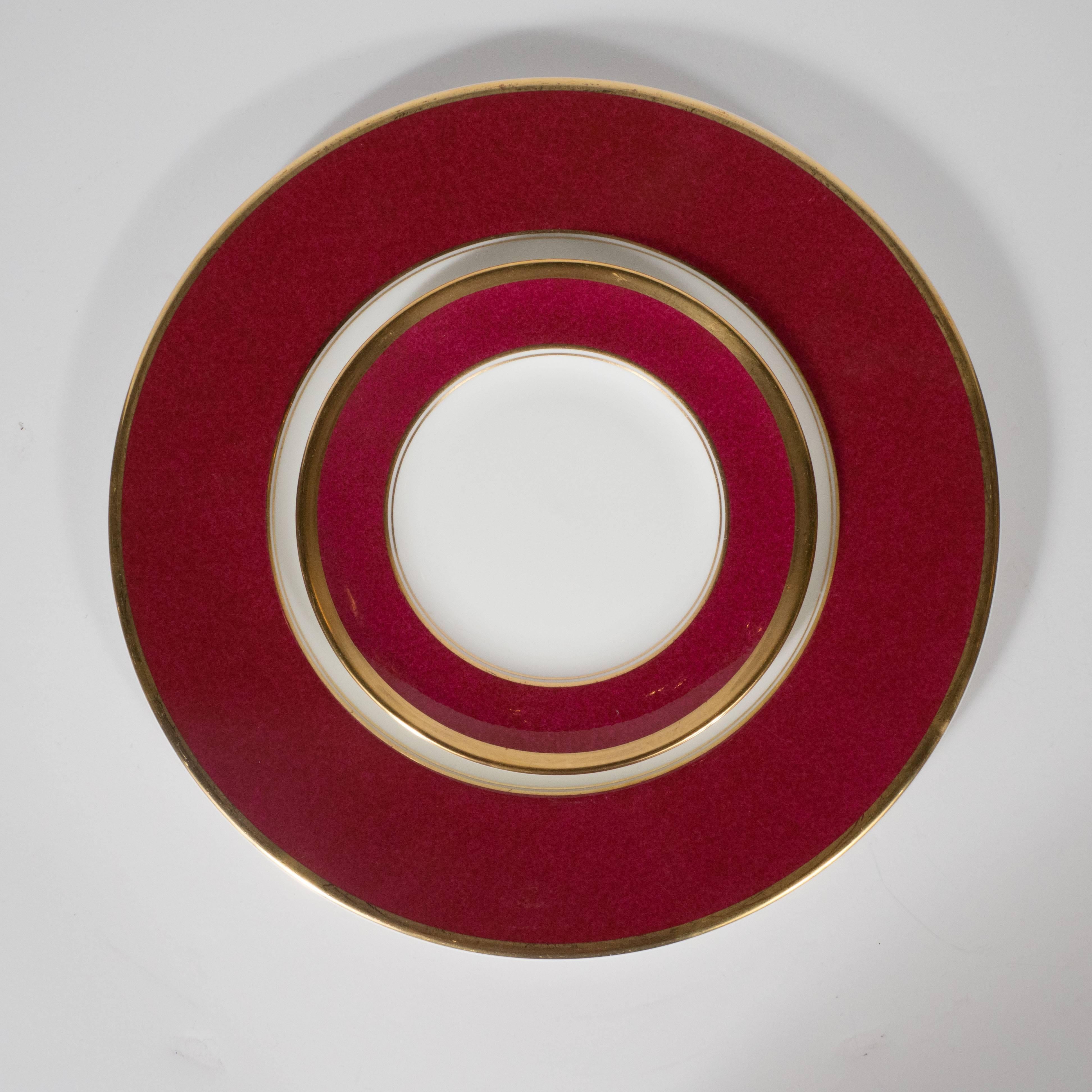 This gorgeous set of Mid-Century Modern bone china dining plates were realized by the esteemed British porcelain producer Coalport, circa 1950. The set includes 24 large dinner plates, and 12 smaller hors d'oeuvres plates. Each plate features three