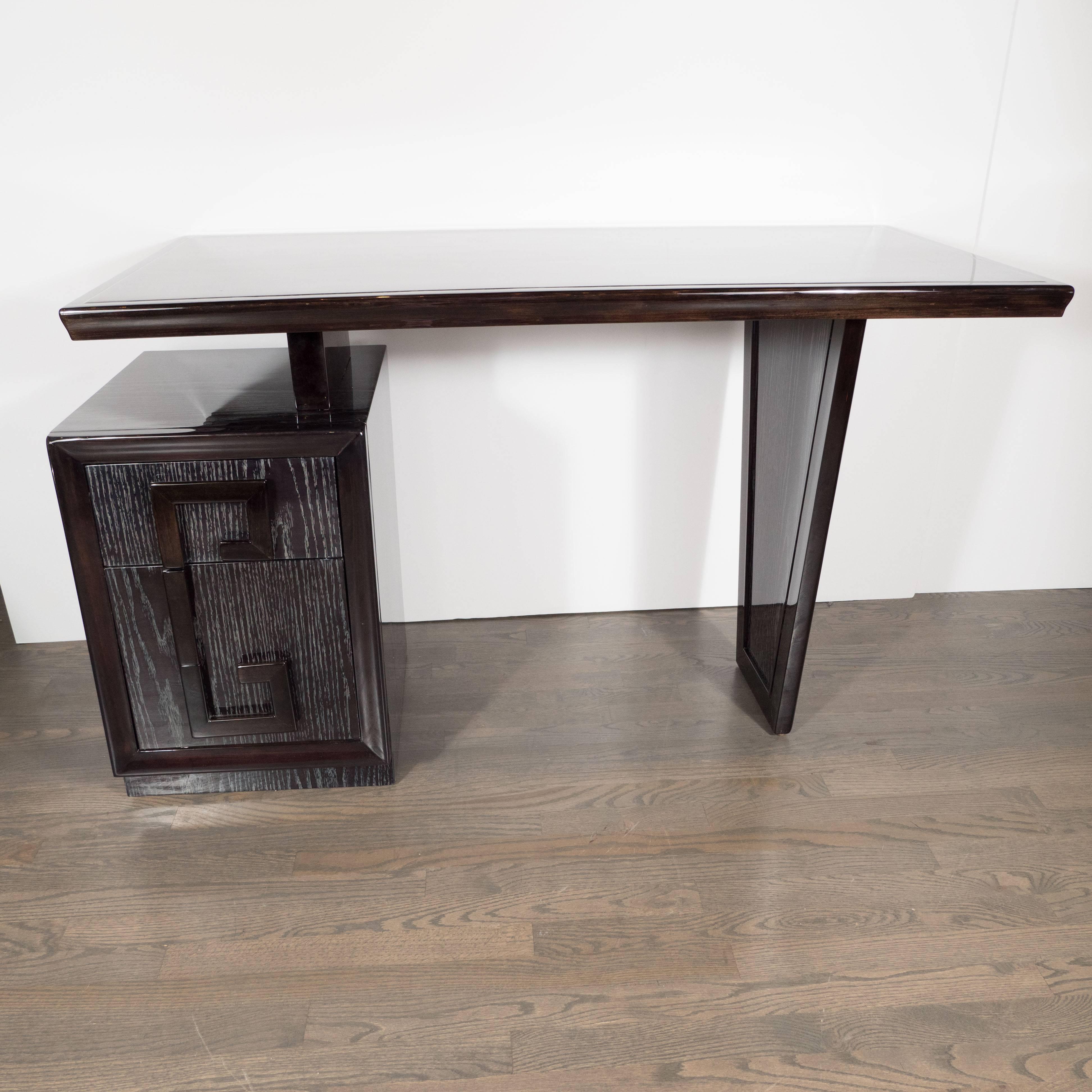 This stylish silver cerused oak desk was realized by the esteemed American maker, Kittenger, circa 1950- the same company responsible for supplying furniture to the white house from the Nixon administration to Obama. The superlative construction and