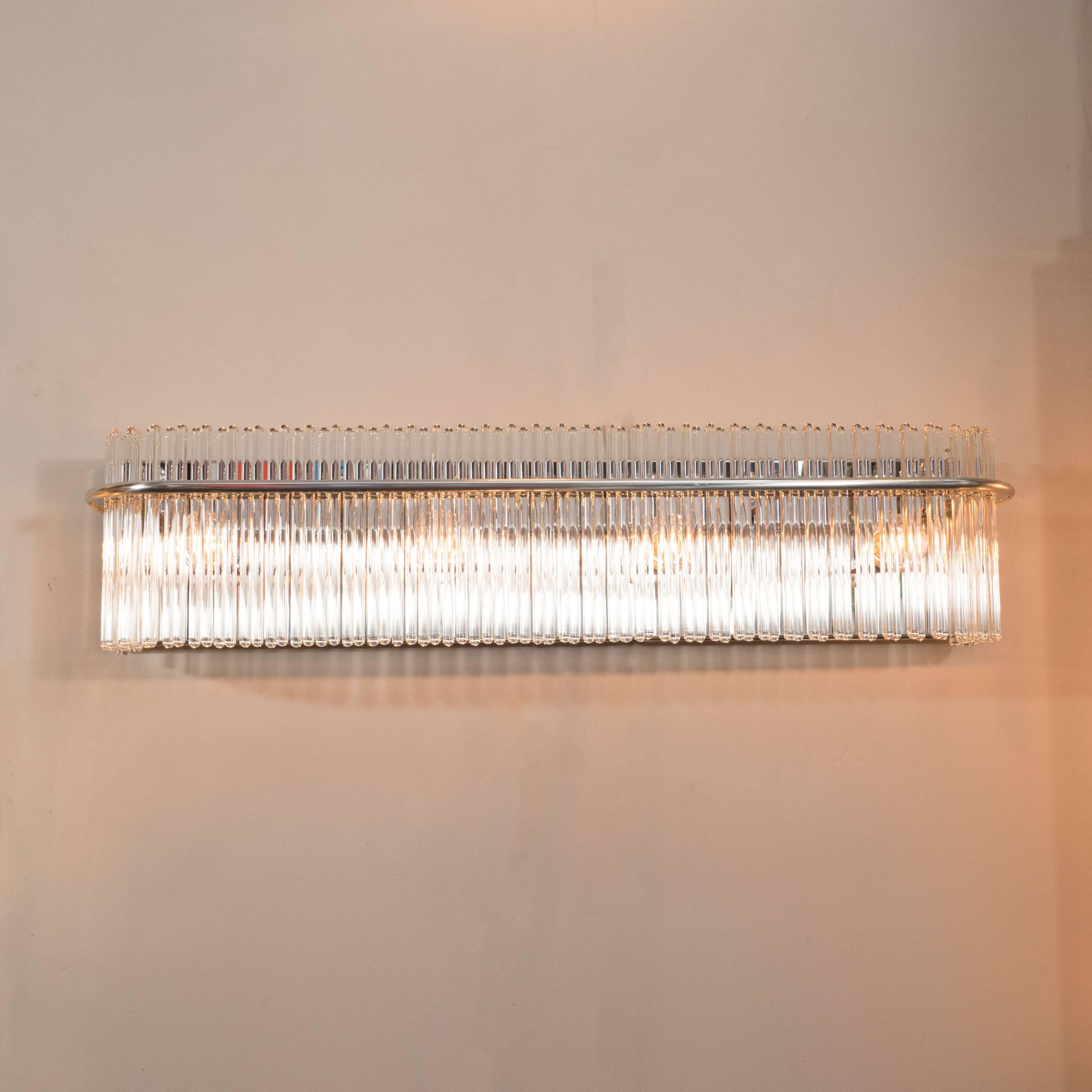 This stunning vanity light features an abundance of translucent glass rods secured with a streamlined brushed chrome rod that attached to a polished brass base. Founded in 1904, the Massachusetts based company Lightolier has specialized in