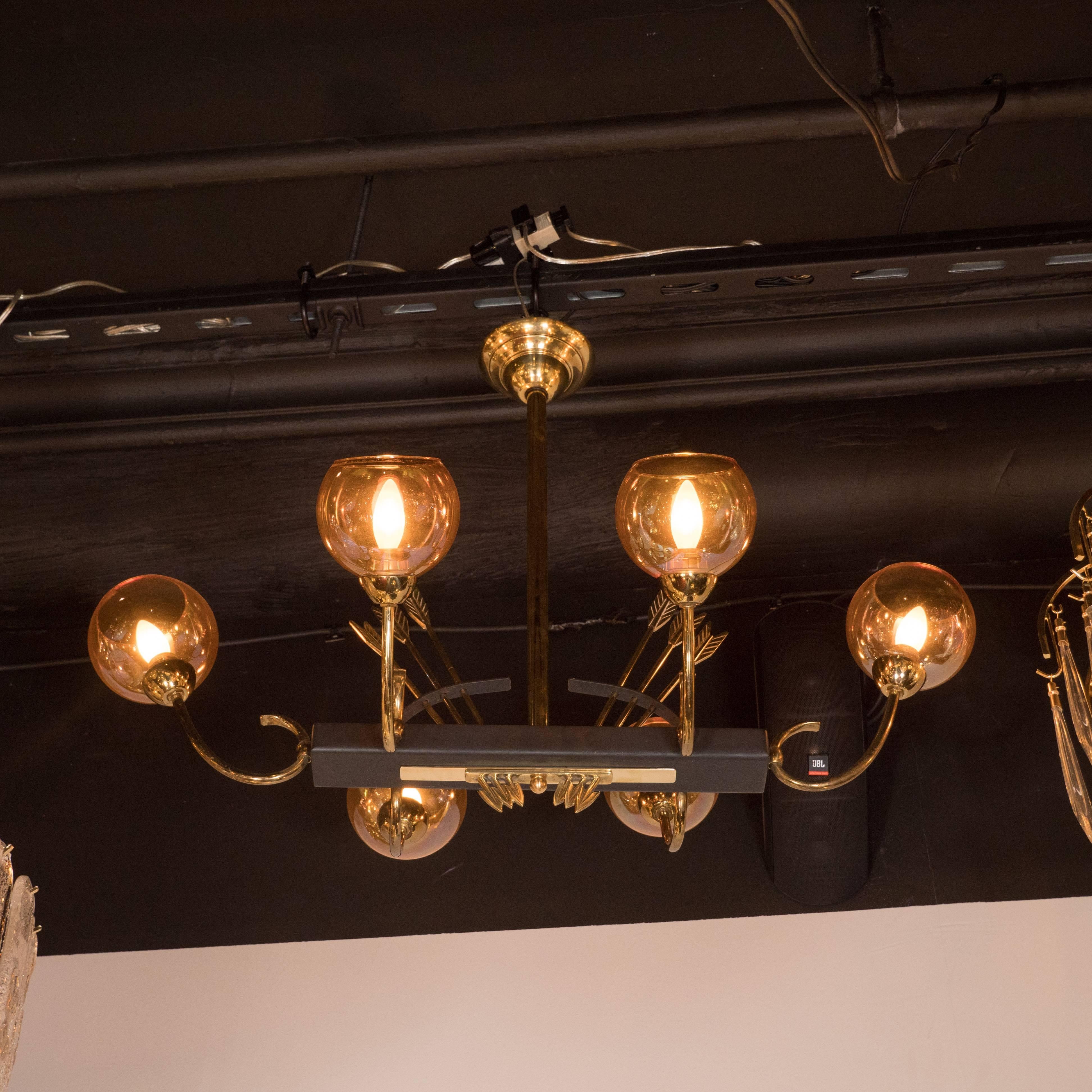 This stunning French Directoire style chandelier features two sets of inverted arrows realized in brass with notched quills piece through a rectangular piece of ebonized walnut. The six arrow heads, also in brass, appear on the other side of the