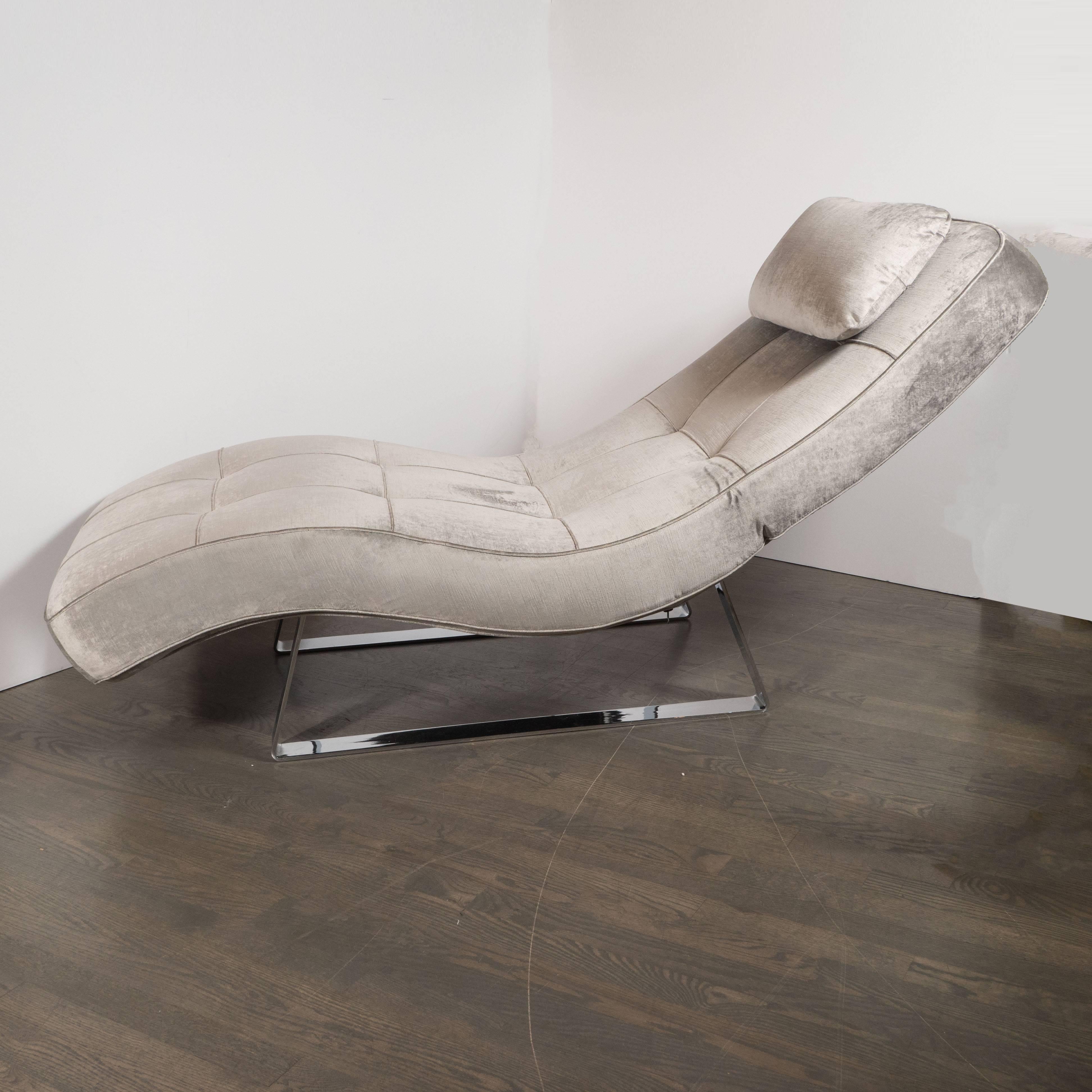 This elegant sculptural chaise is full of interesting contrasts- the undulating curves of the body juxtaposed with the rectilinear base, the softness of the velvet (both in visual and tactile terms) upholstery and the metallic rigidity of the chrome