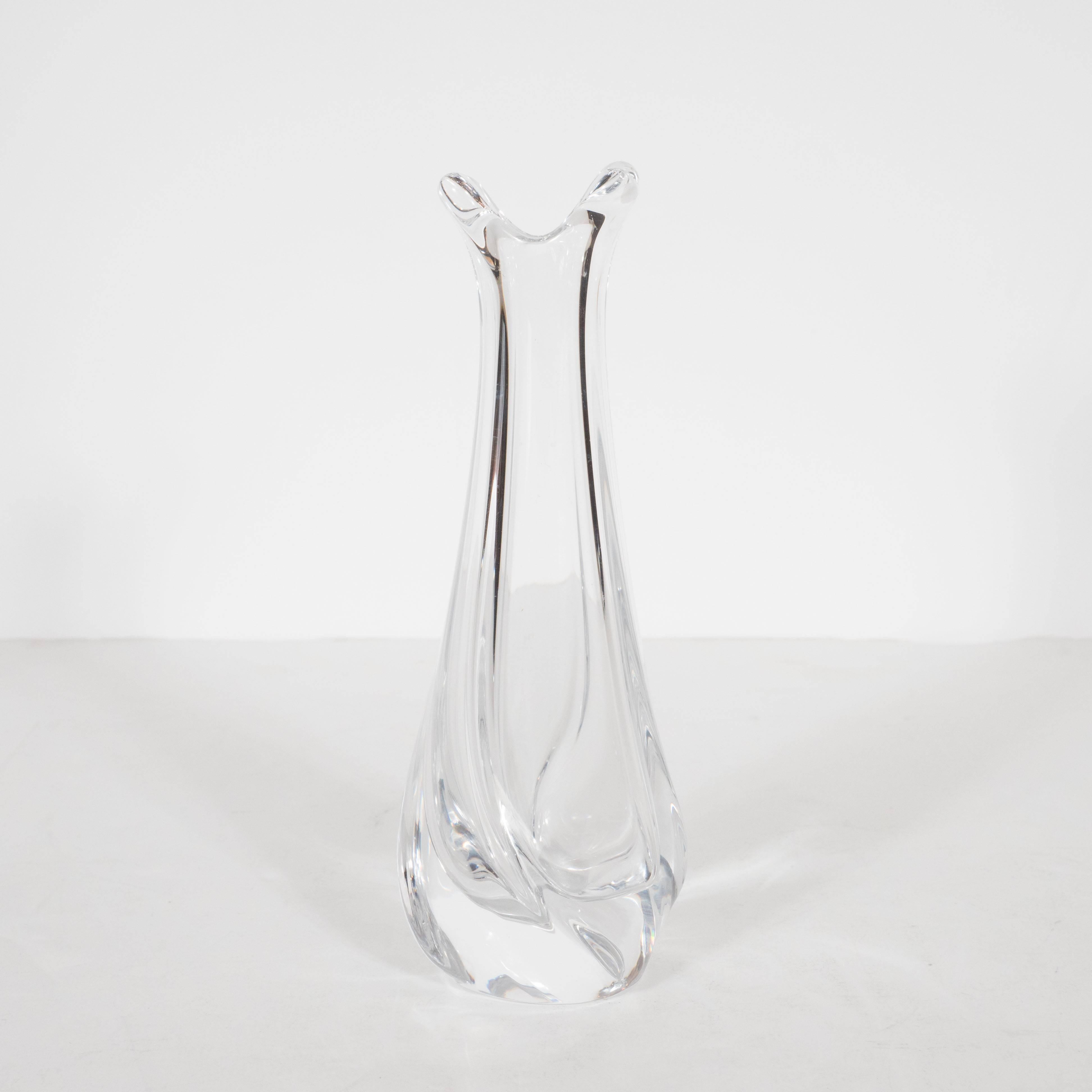This stunning vase was handblown in France by Daum, one of the most esteemed French glass studios of the 20th century. It offers a sinuous curved rectangular form with two billowing lips at the top suggesting splashing water. The translucent form is
