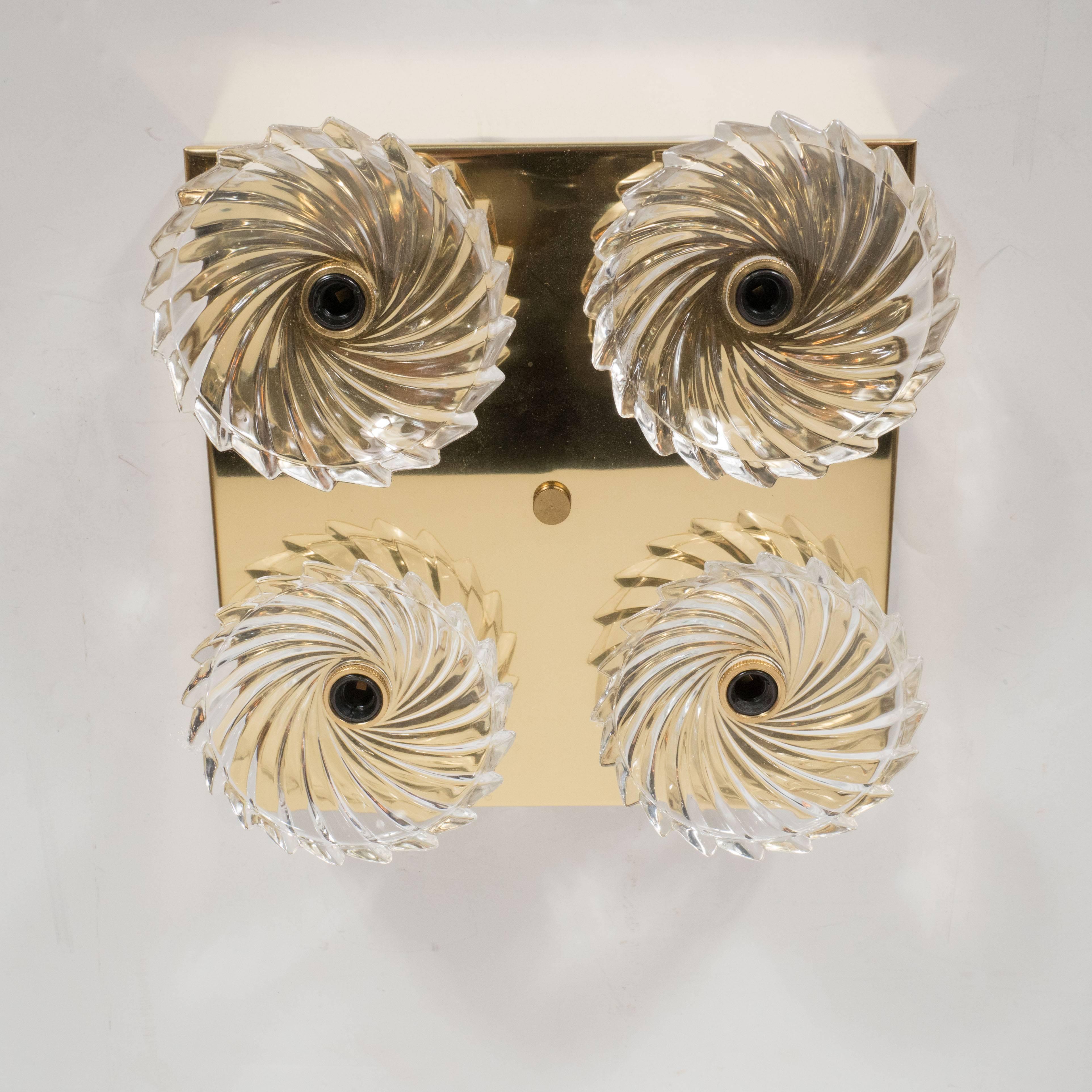 This gorgeous pair of Mid-Century Modernist flush mounts feature four pinwheel bobeche clear glass shades fitted on a low profile square brass base. These flush mount accommodate four candelabra base bulbs providing up to 240 watts of light. They