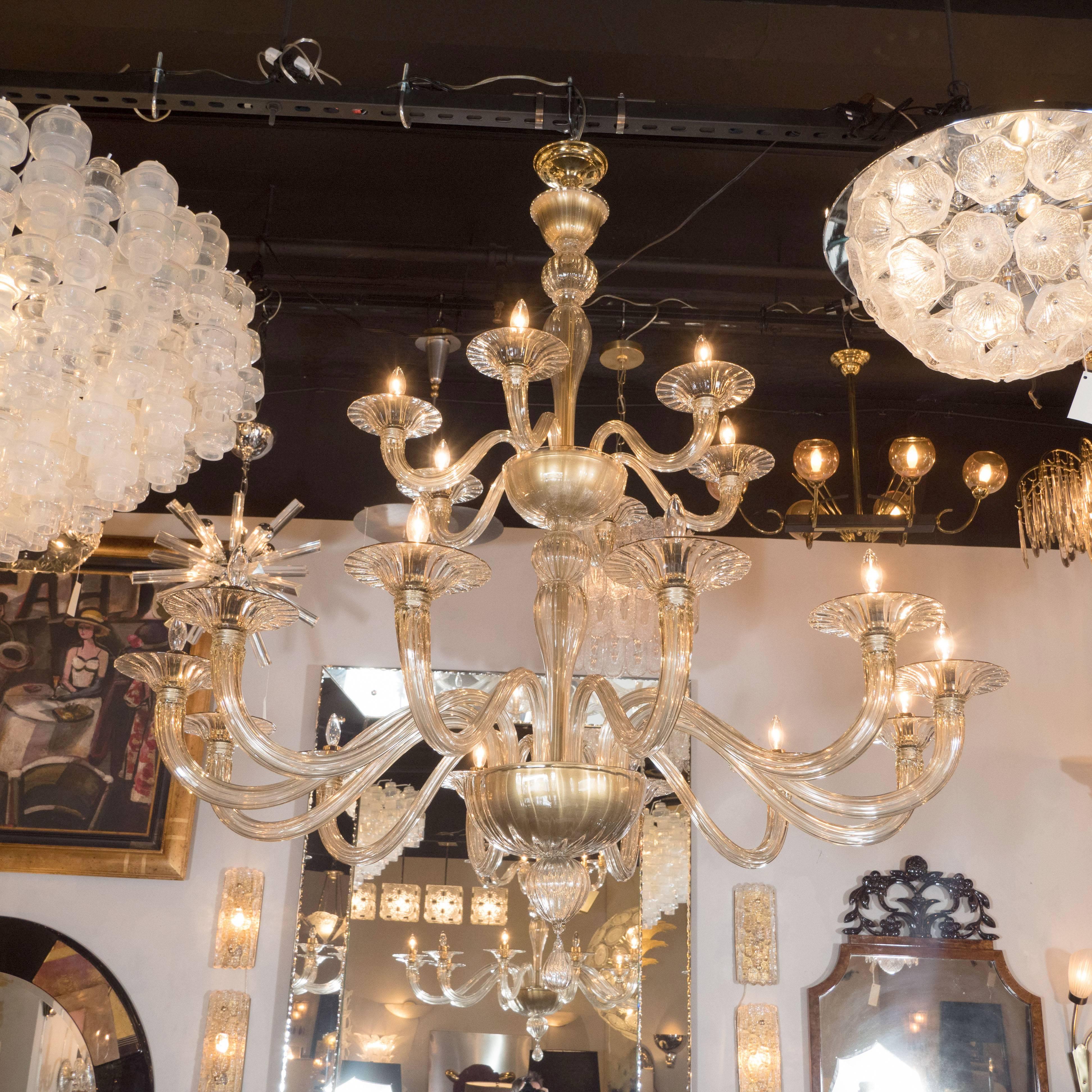 This stunning chandelier was handblown by the fabled Murano glass studio, Barovier e Toso, in Italy, circa 1960. It features six reeded scroll form arms, culminating in a bobeche, that connect to an inverted domed form in champagne glass. Two reeded