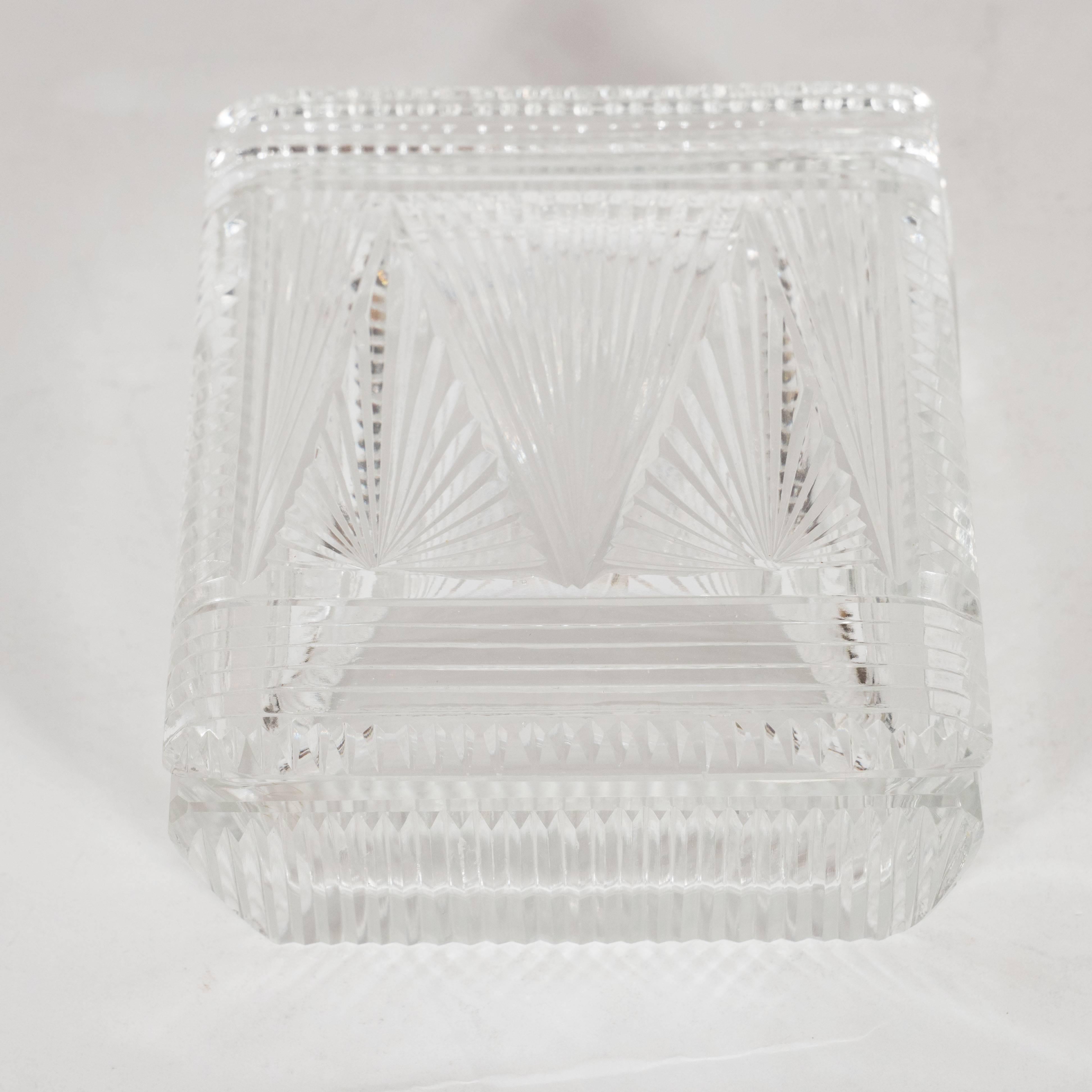 This exquisite Art Deco box was handblown and etched in Czechoslovakia- a country renowned for its superlative glass production during this period circa 1935. The top features three starburst etched isosceles triangles in the center flanked on each
