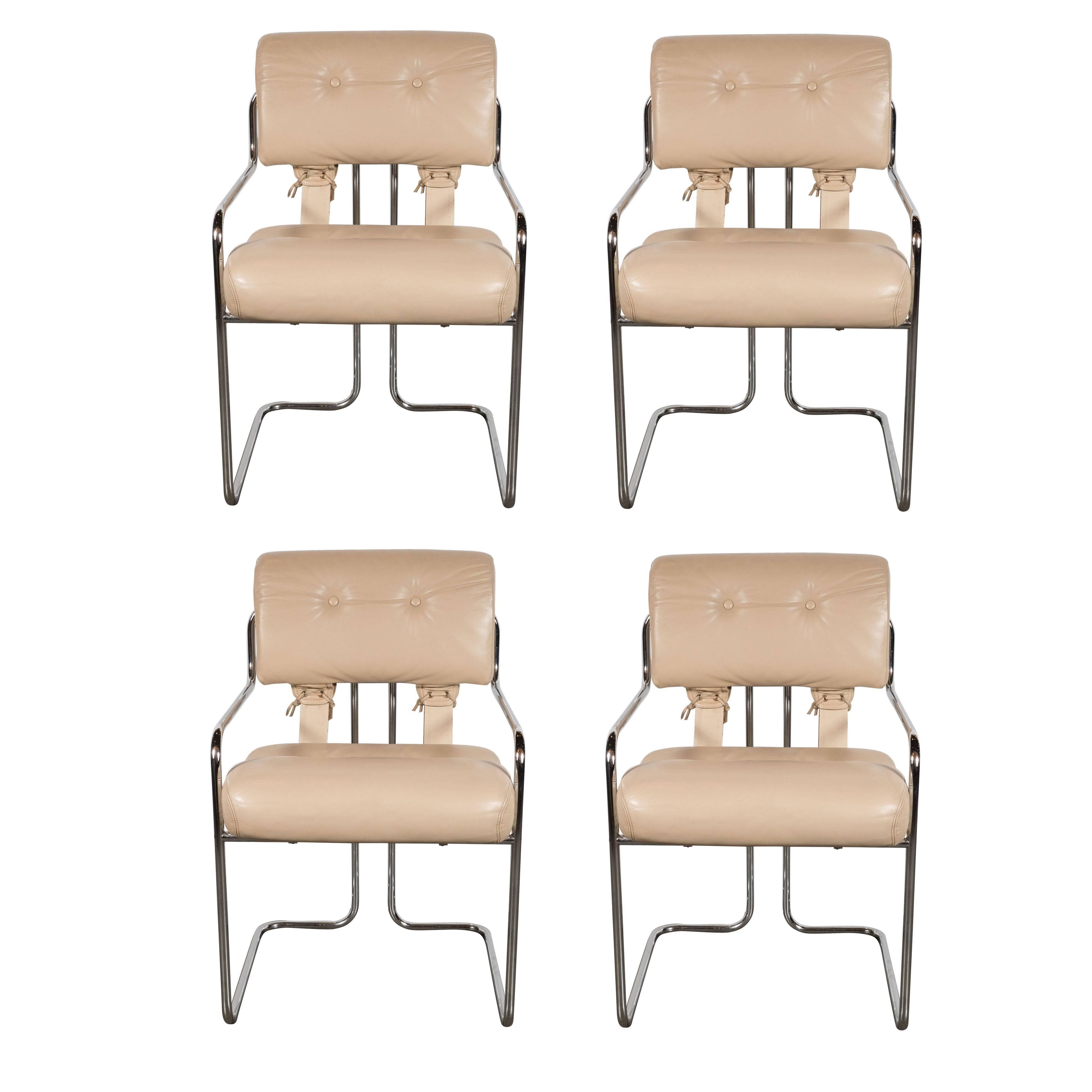 Set of four Mid-Century Modernist dining chairs by Guido Faleschini by Mariani for Pace Collection. Tubular bent steel frames support button-tufted leather upholstered seats and backs. They are fastened in the back with leather saddle-stitch. The