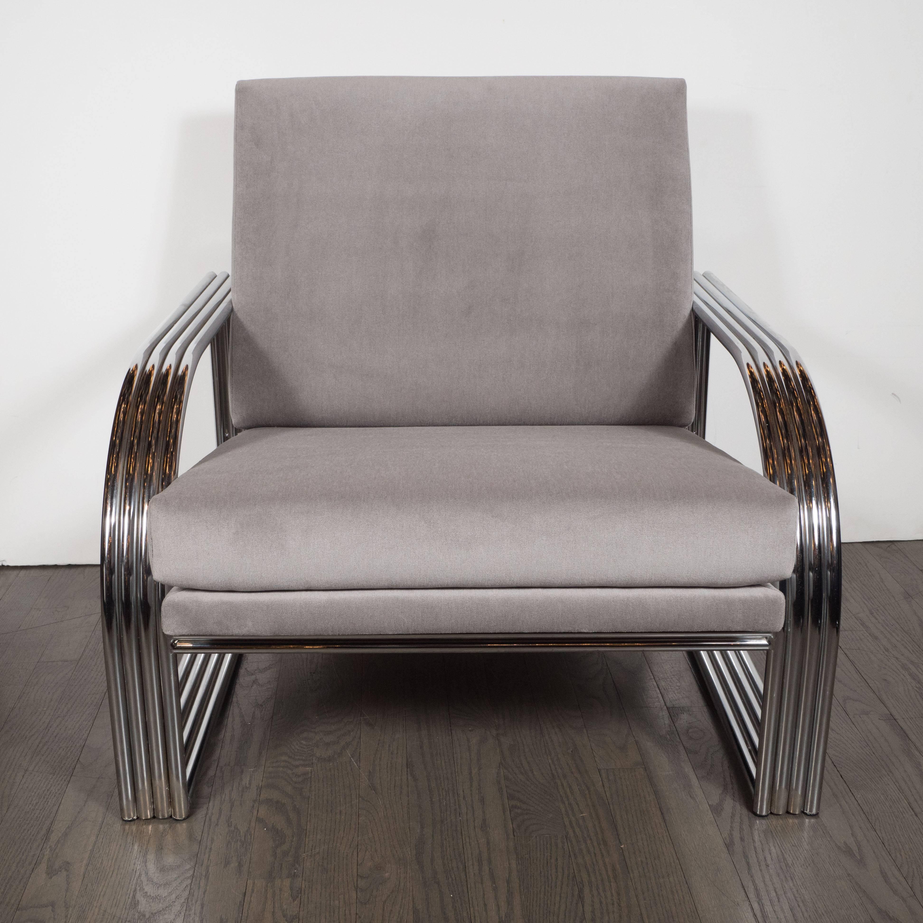 This dramatic and graphic Art Deco inspired club chair was designed in the manner of Jay Spectre, circa 1980. This chair features banded streamlined arms, consisting of four bent chrome bars welded together that elegant curve on the sides. The arms