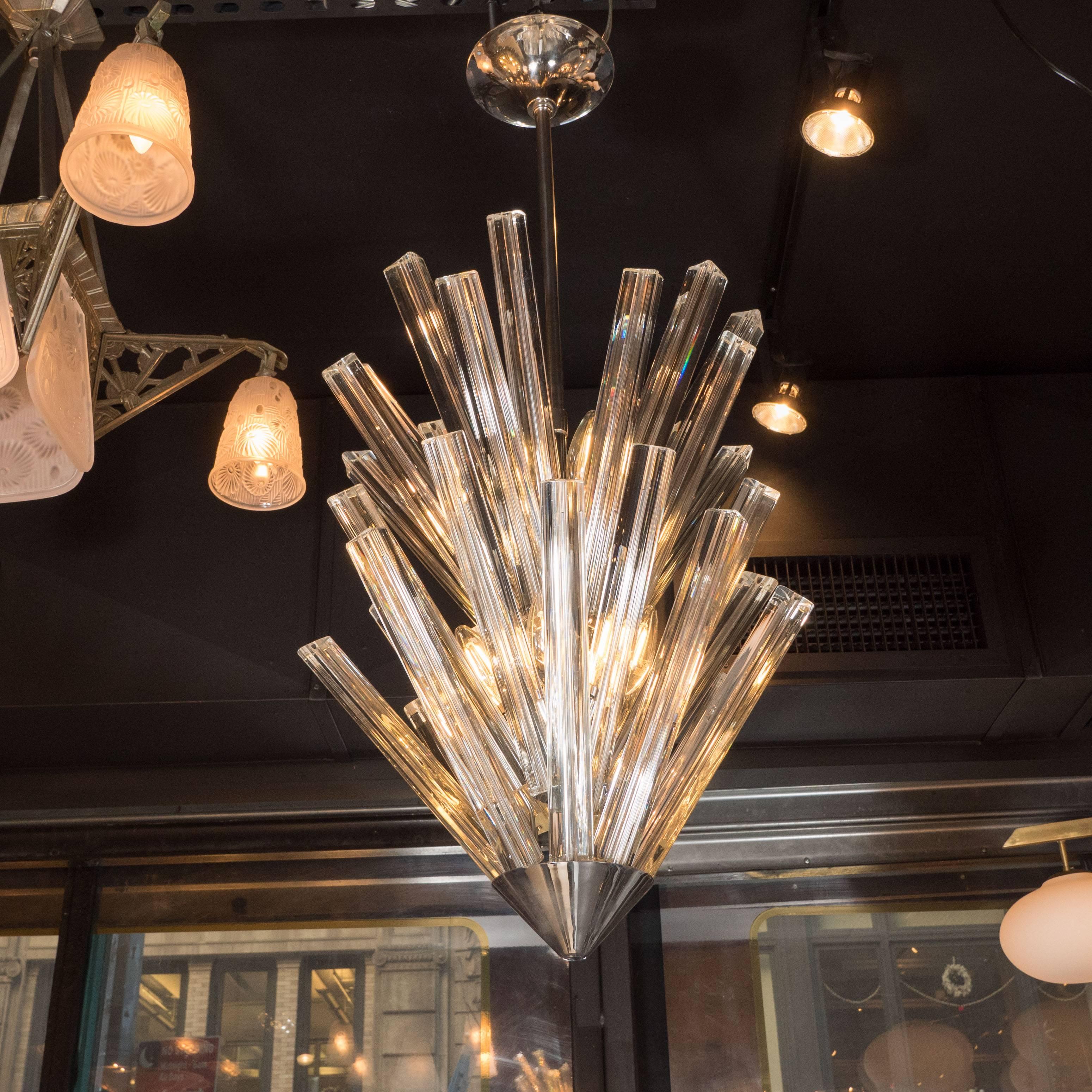 This stunning and graphic mid-century modern starburst chandelier was realized in Italy, circa 1970. It features four tiers of translucent camer crystals of differing lengths that extend upwards at an angle, imbuing it with dynamic energy, as well