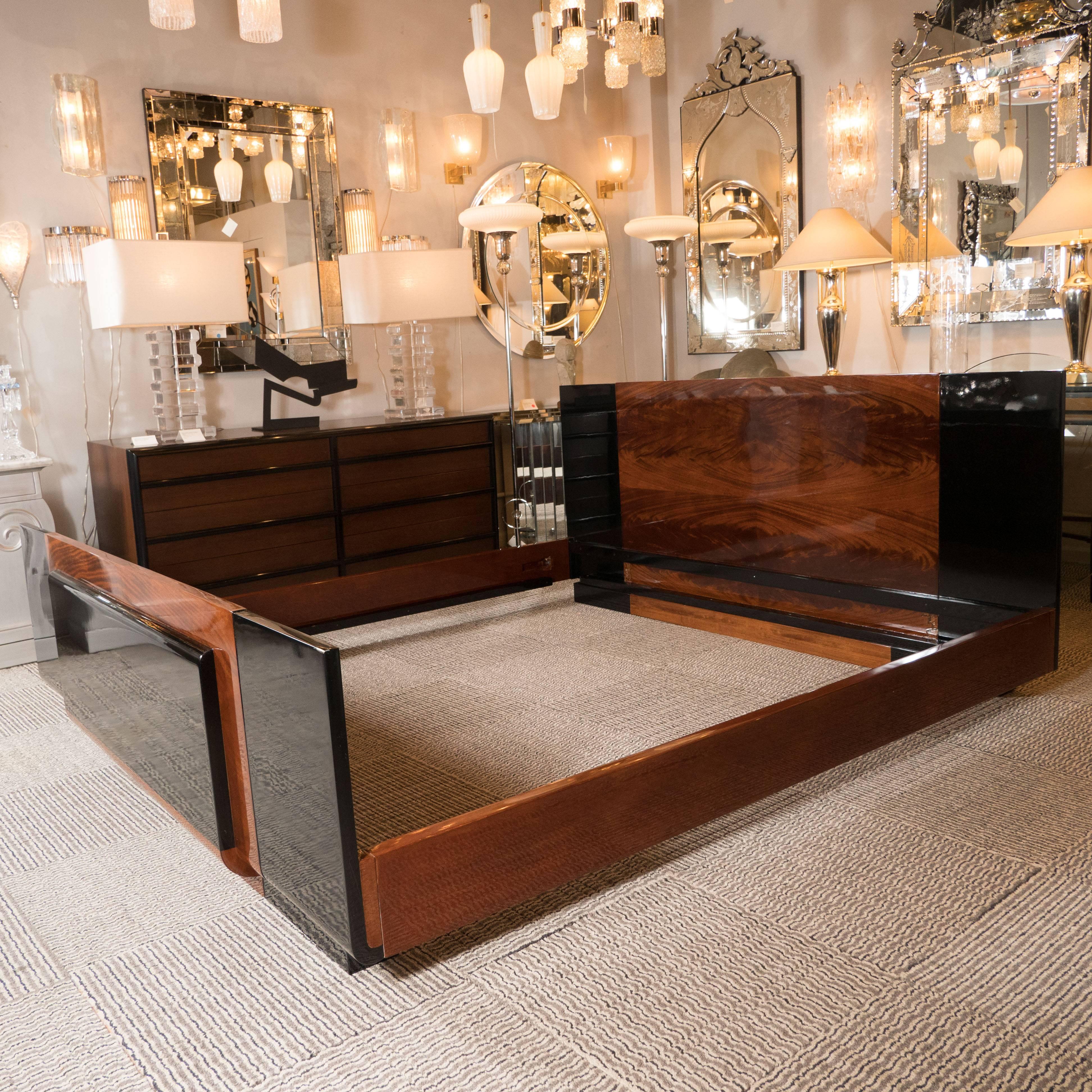 This rare and important Machine Age king-size bed set was realized by Donald Deskey- the fabled American designer behind Radio City Music Hall, circa 1935. It features bookmatched burled walnut interspersed with blocks of black lacquer. With its