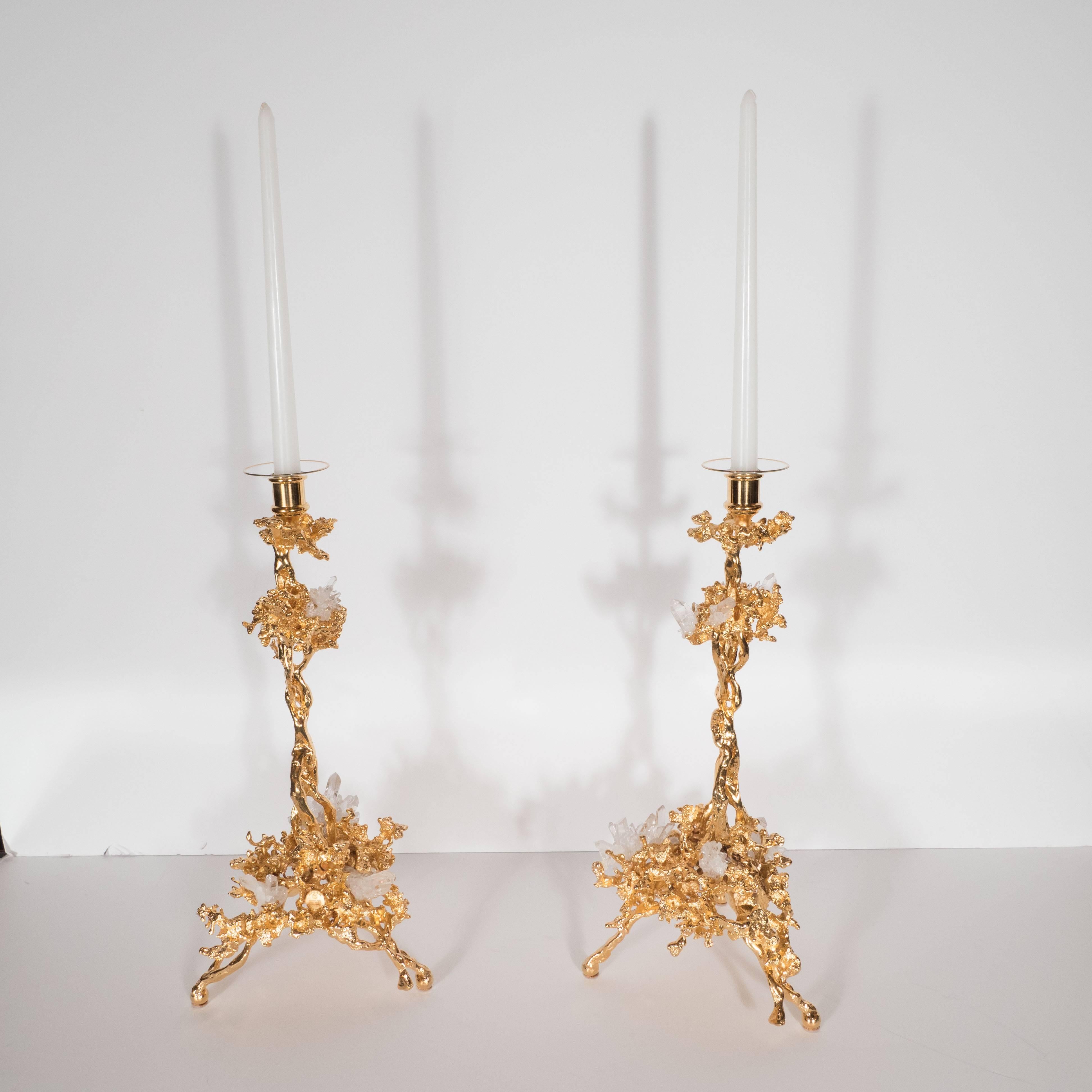 This stunning pair of Mid-Century Modern candlesticks were realized in France, circa 1970 by the esteemed artisan Claude Victor Boeltz. They offer an exploded form sculpted, by hand, and cast in bronze, consisting of a single arm and three feet