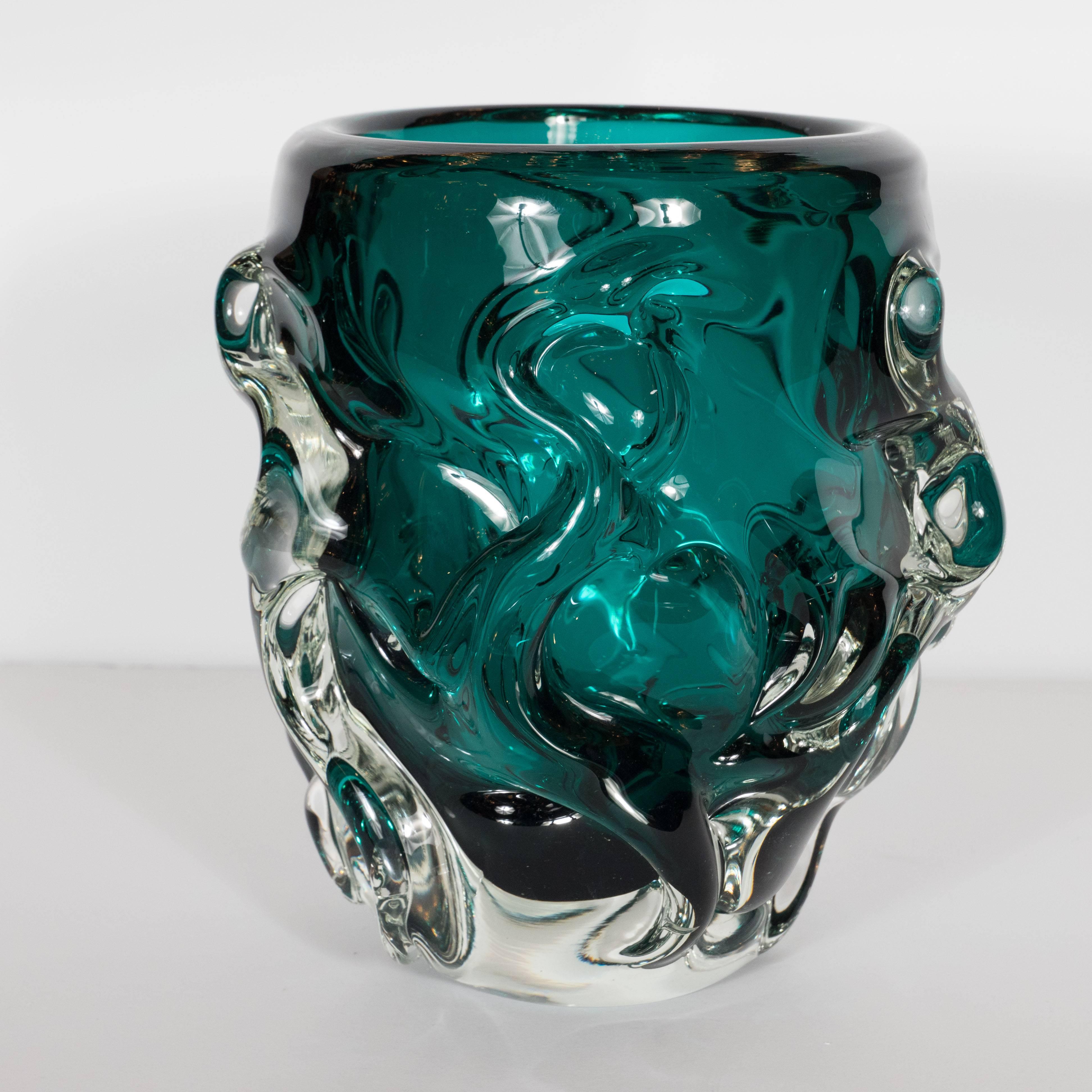 This gorgeous vase was realized in Murano, Italy- the islands off the coast of Venice that have been renowned for centuries for their superlative glass production, circa 1960. They feature highly textural exteriors composed of raised undulating