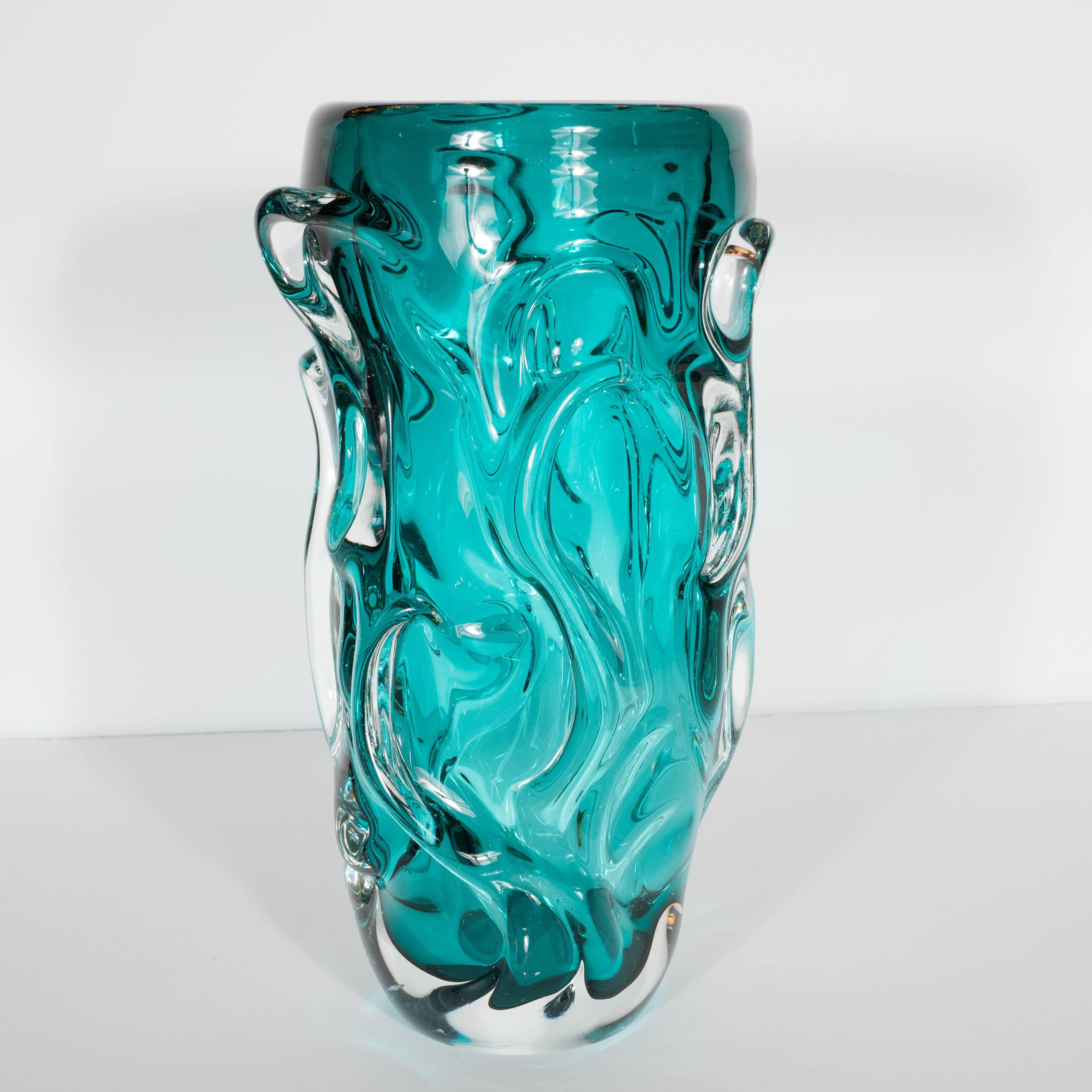 This gorgeous vase was realized in Murano, Italy, the islands off the coast of Venice that have been renowned for centuries for their superlative glass production, circa 1960. They feature highly textural exteriors composed of raised undulating