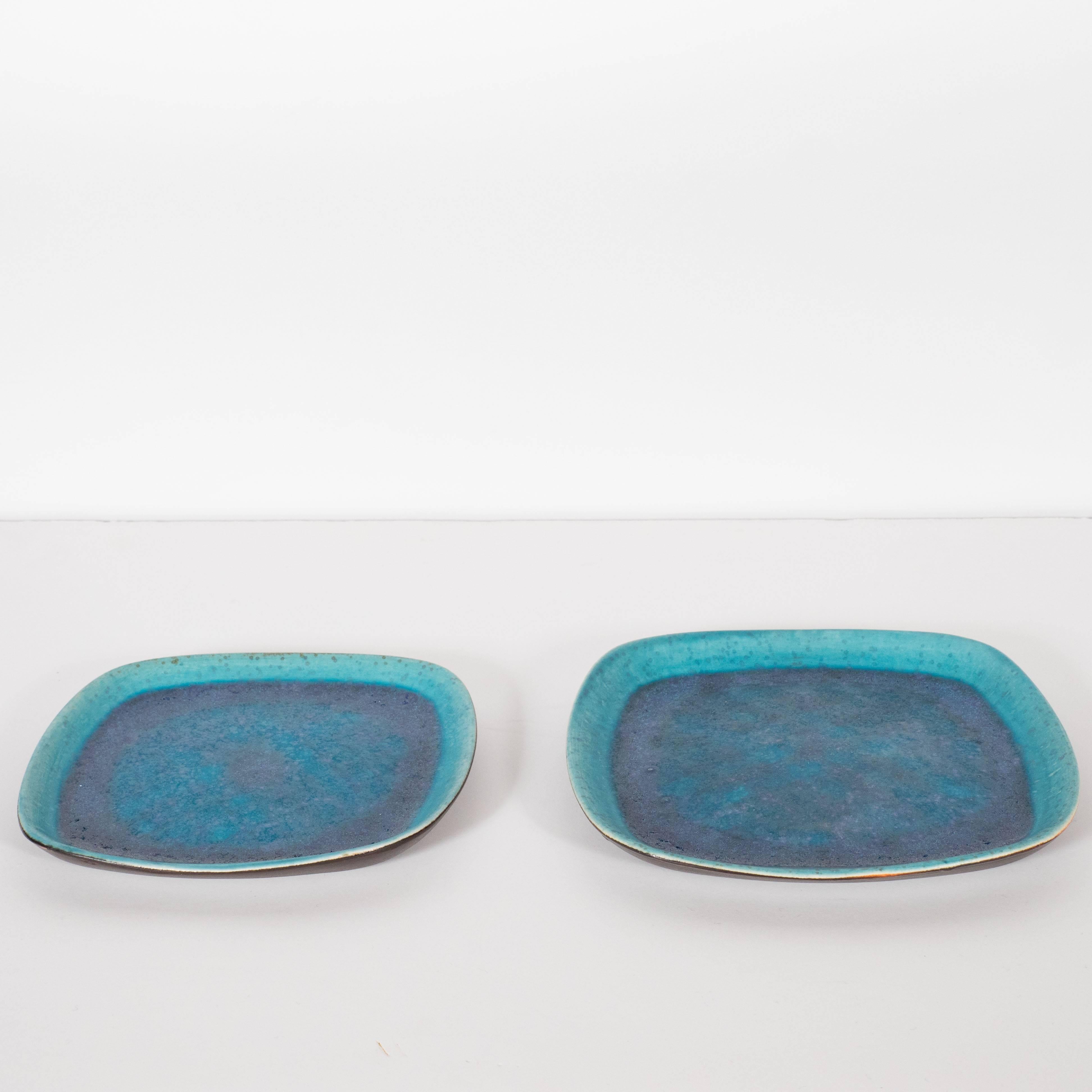This stunning pair of Mid-Century Modern trays were realized in the United States, circa 1966, by Francis Joseph Von Tury. Born into a family that had operated its own ceramic plant in Transylvania for four generations, Mr. Von Tury spent his