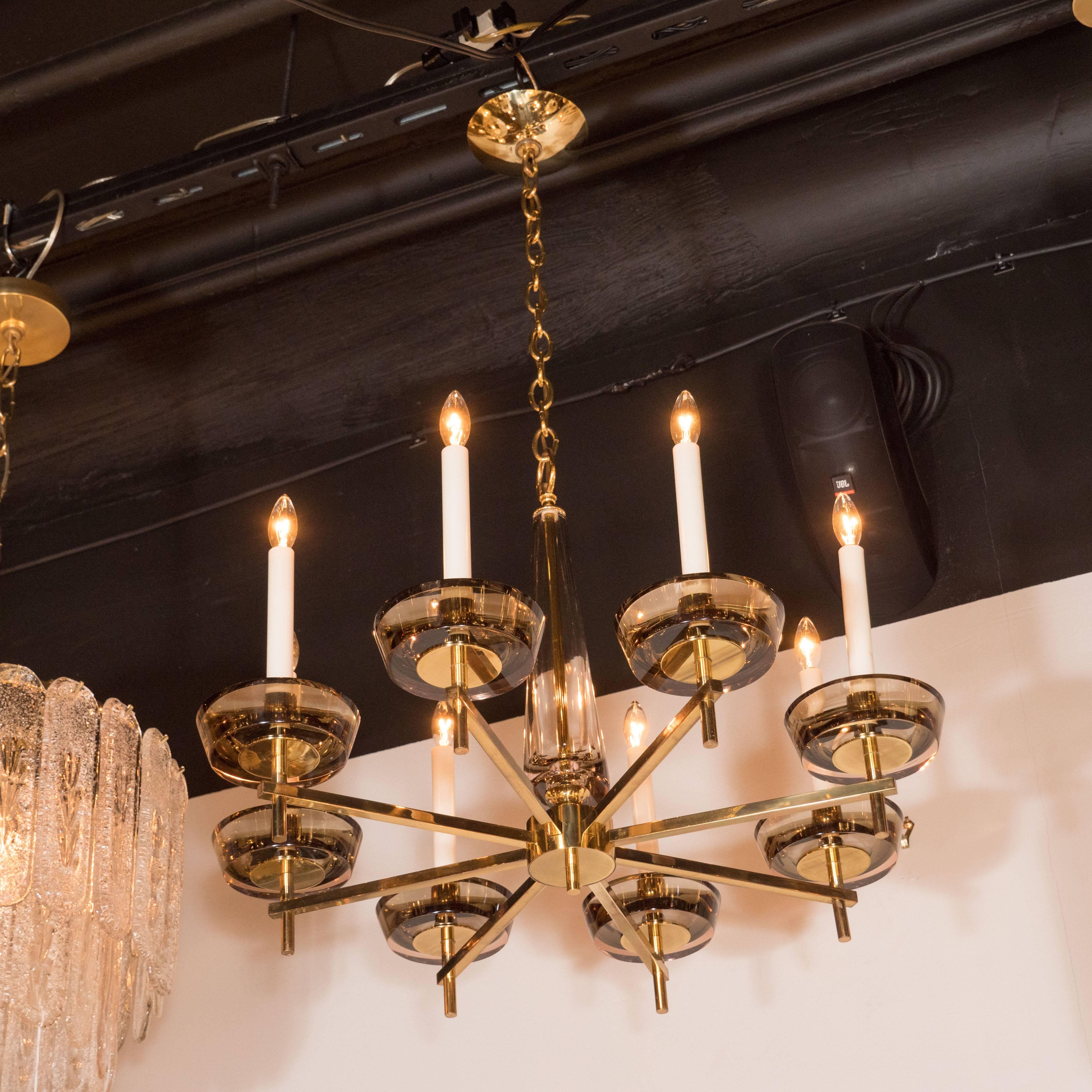This stunning and graphic eight-arm chandelier was realized in Italy, circa 1960. It features eight fine rectangular arms that connect to smoke glass cupolas each housing a single candelabra based bulb. The arms attach to a cylindrical body with a