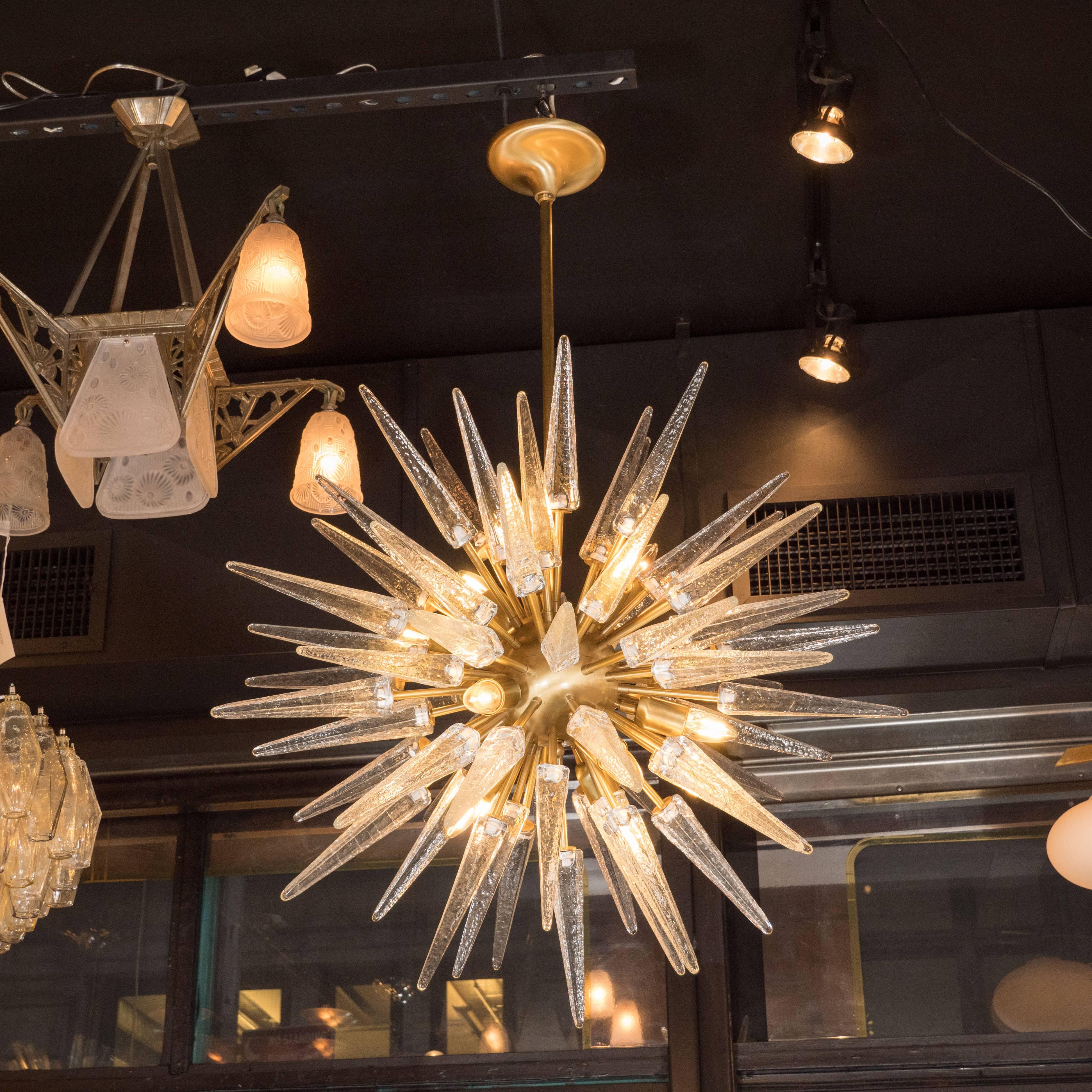 This stunning modernist Sputnik was realized by our custom atelier in Murano, Italy- the islands off the coast of Venice renowned for centuries for their superlative glass production. It features an exploding sunburst form consisting of an abundance