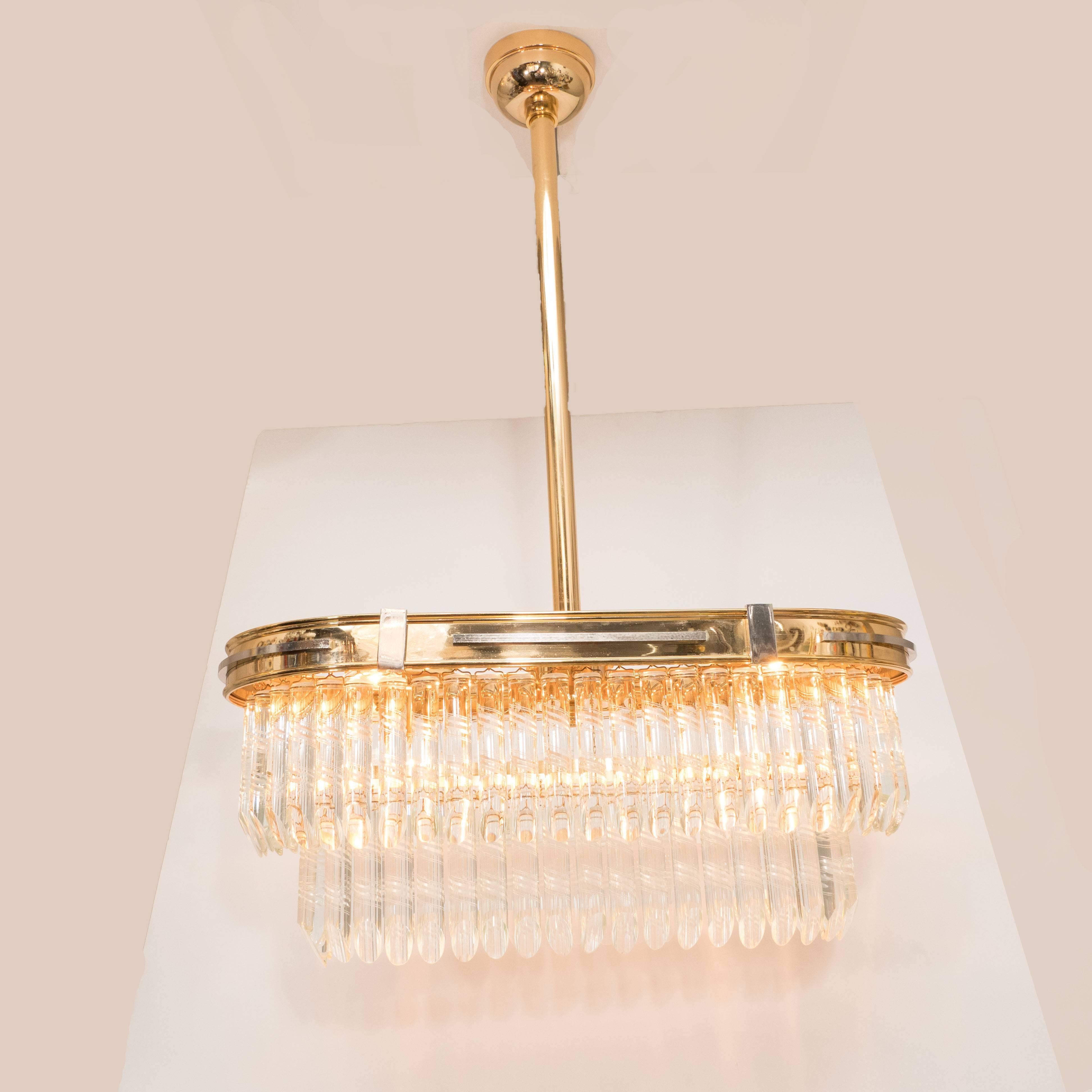 Mid-Century Modern Oblong brass and nickel chandelier with cut-crystals. This stunning and refined Mid-Century Modern chandelier was realized in Italy, circa 1970. It features an oblong streamlined frame- resembling the form of a racetrack- in brass