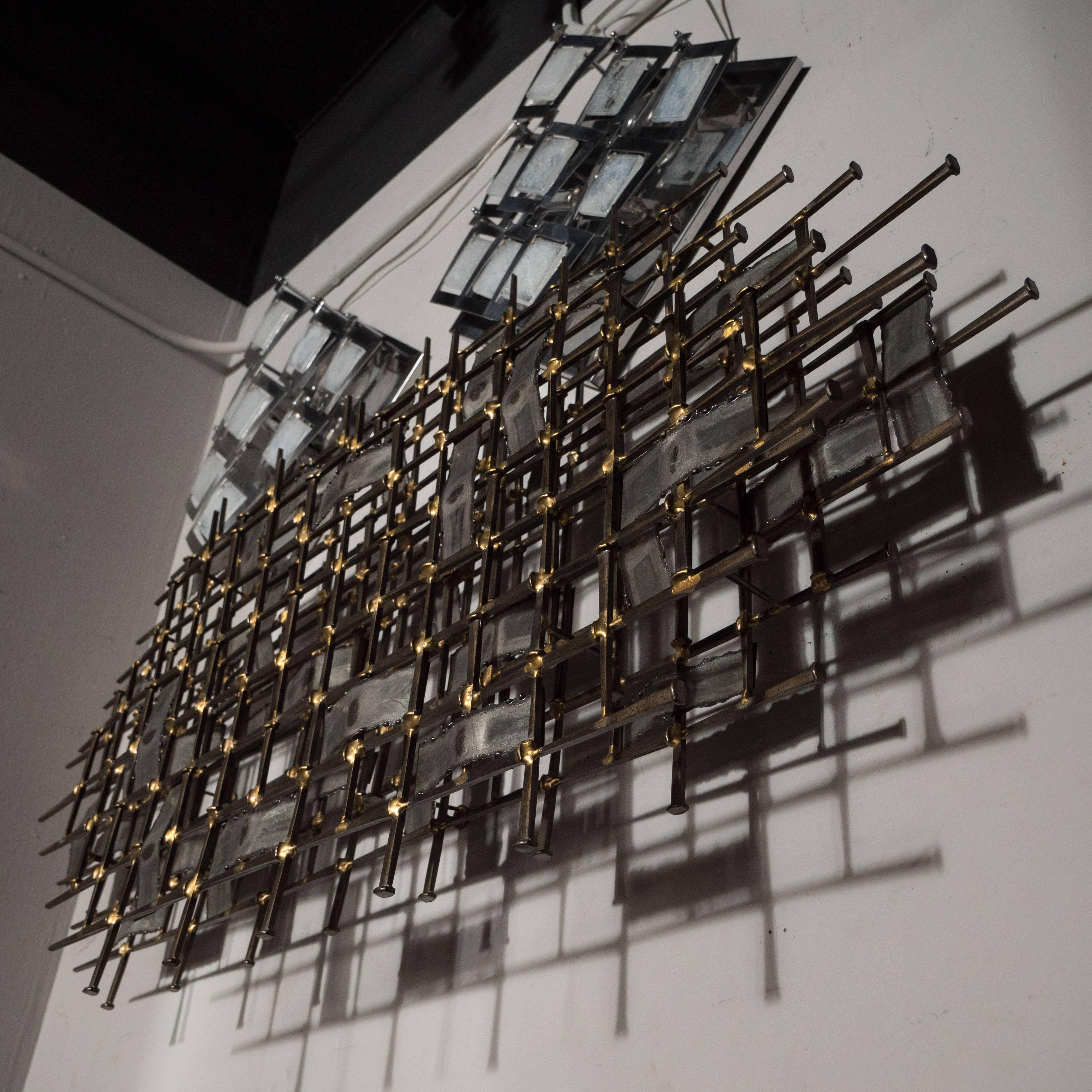 This sophisticated Mid-Century Modern sculpture- realized in the manner of Silas Seandle- was realized in the United States, circa 1970. It consists of a lattice work of rectangular tapered steel forms- resembling oversized nails- adjoined by