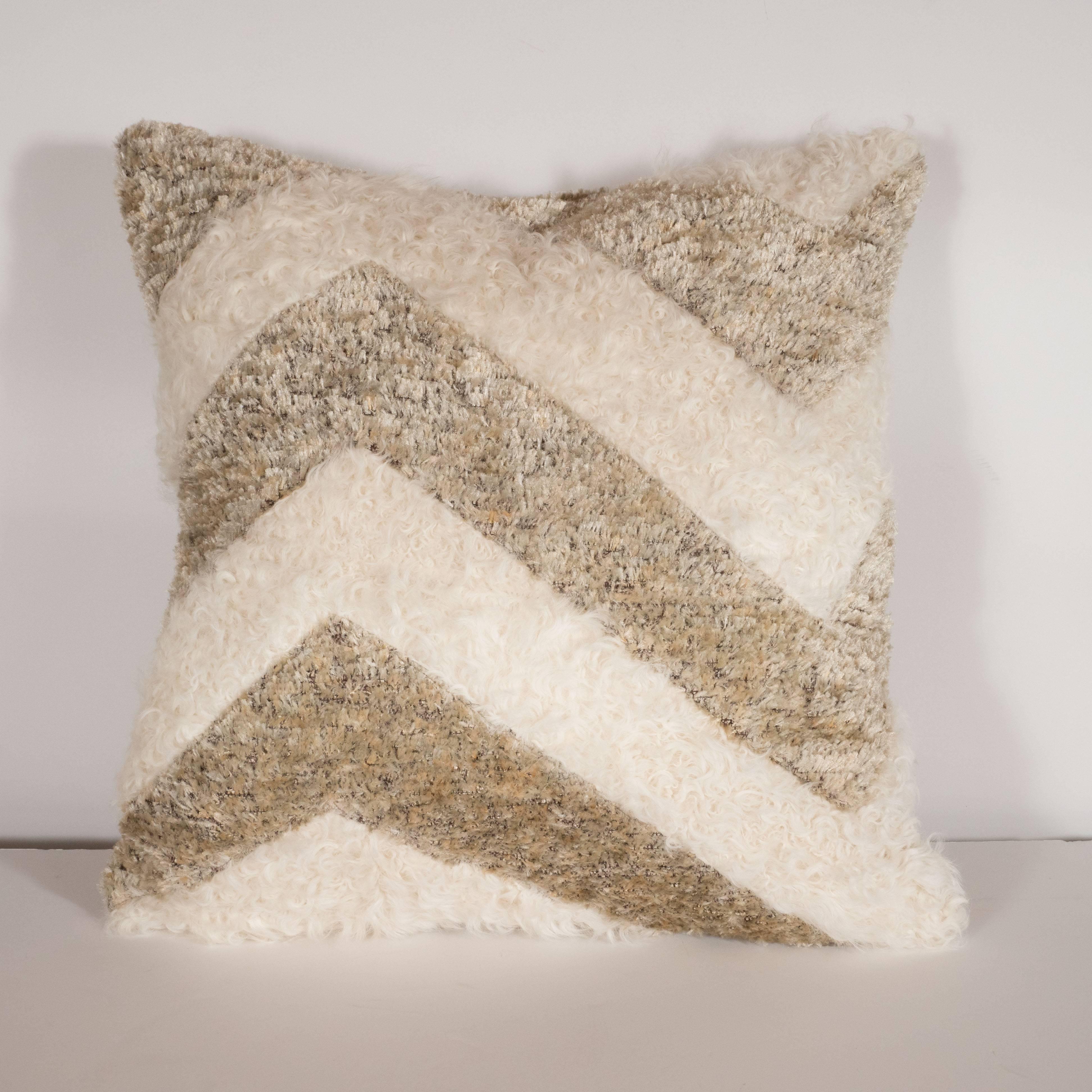 This stunning and elegant modernist pillow was custom designed in the United States. It features a solid back composed of a silk/wool/synthetic blend, and a chevron pattern with alternating zigzagging bands of this fabric contrasted with inlaid