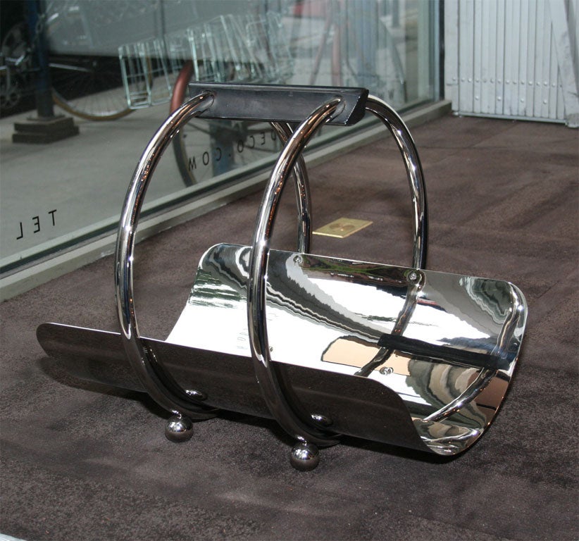 This iconic American streamlined Machine Age Art Deco design- often misattributed to Norman Bel Geddes- was designed by Leslie Beaton for the Revere Company, circa 1935. The belly of the holder is composed of a curved sheet of chrome, encircled by