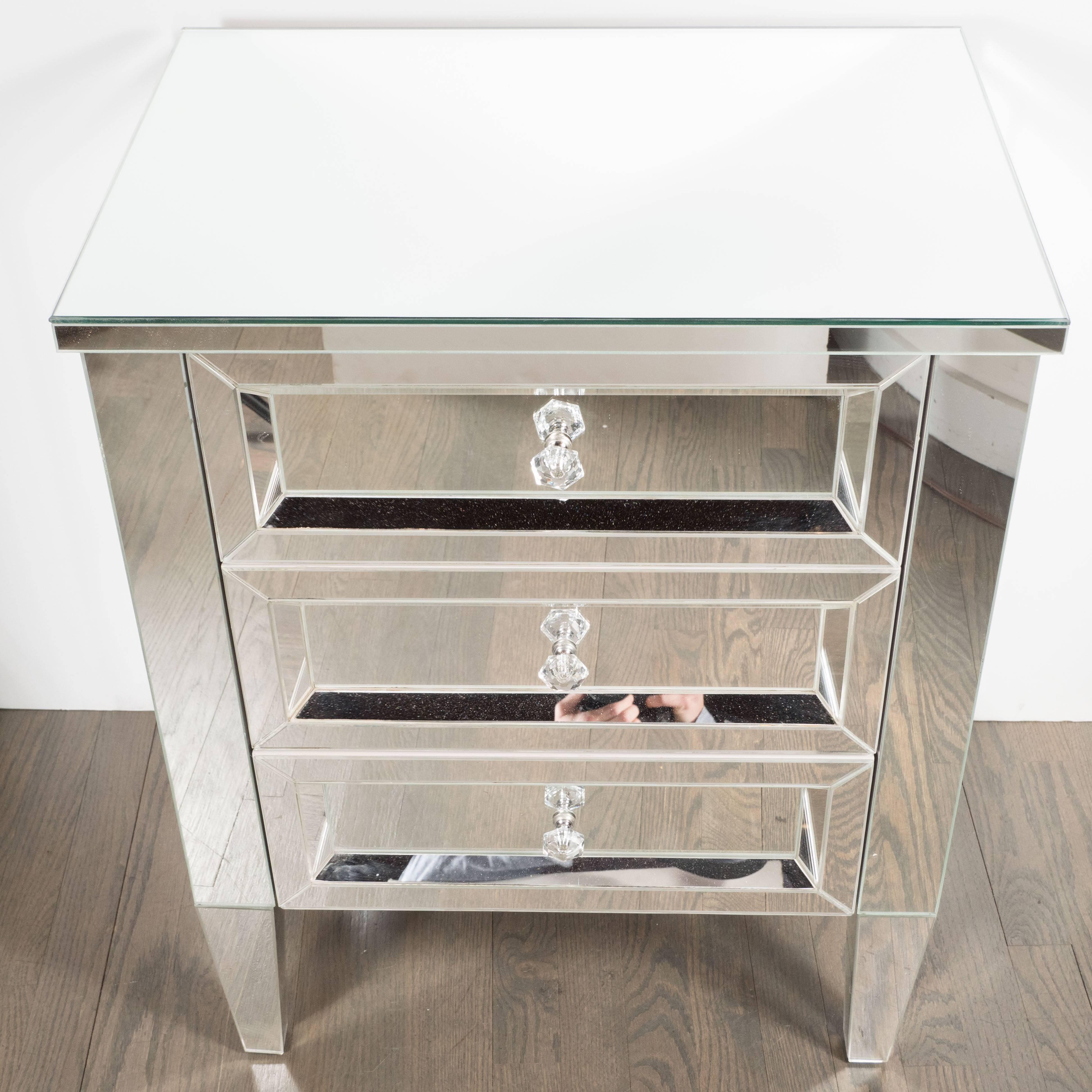 This stunning pair of Hollywood Regency inspired nightstands were custom-made by our exclusive atelier in New York. They embody the superlative craftsmanship, old world glamour, and attention to detail that we prize. Composed of mirrored glass, they