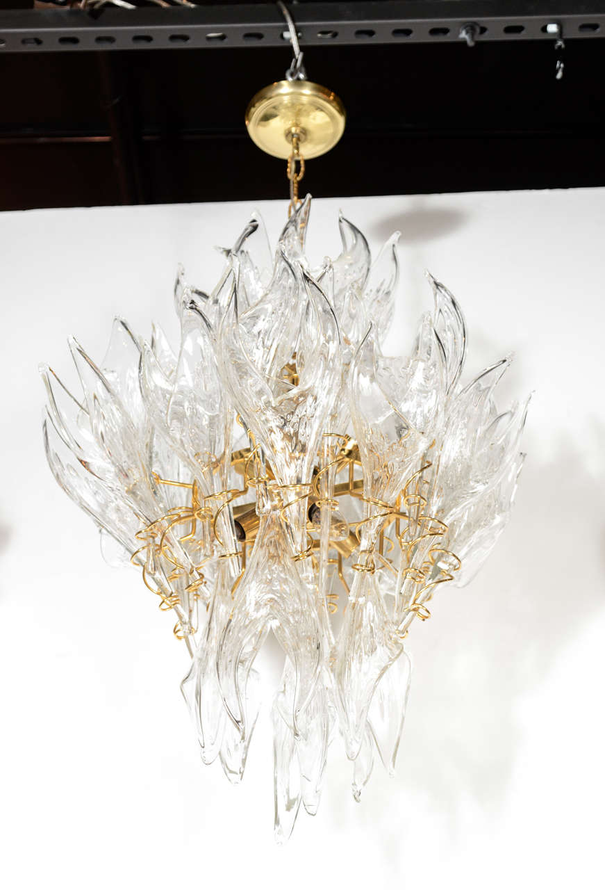 This striking and graphic Mid-Century Modern chandelier was realized by the illustrious Italian glass studio, Mazzega, in Murano, circa 1970. The chandelier offers an abundance of unique handblown Murano glass translucent shades- resembling stylized