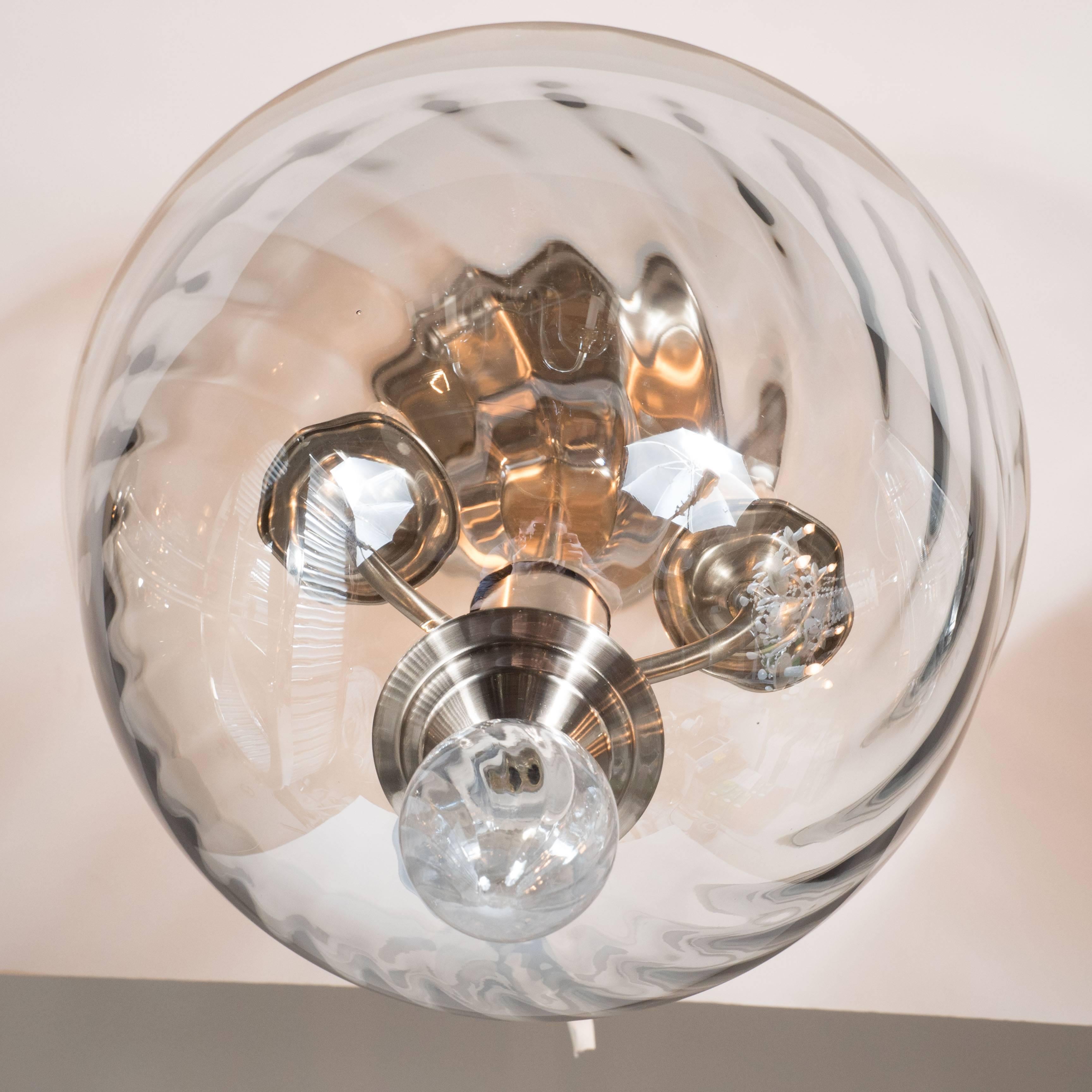 An Italian Mid-Century Modernist hand blown Murano glass reverse-dome swirled detail glass flush mount chandelier. Nickel fittings throughout, as well as a droplet glass finial detail complete the piece. Completely rewired and in excellent