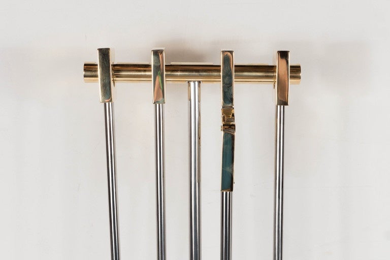 This custom chic modernist four-piece fire tool set consists of a shovel, brush, poker and log holder. Each piece hangs neatly on a T-frame by the square polished brass handle. Ask for finish options. They are in mint condition.